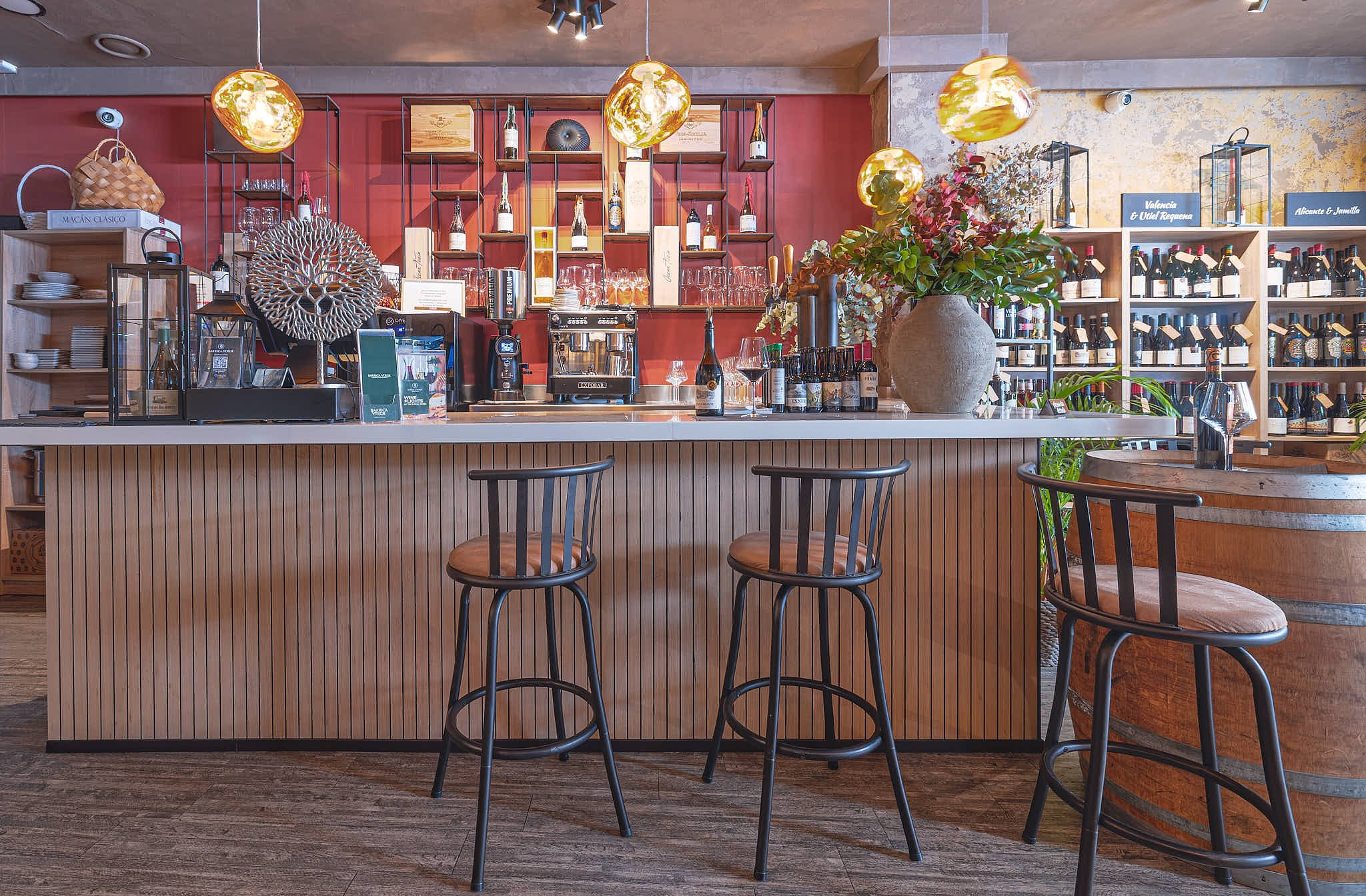 Bar area with high stools and lighting in a restaurant in Valencia