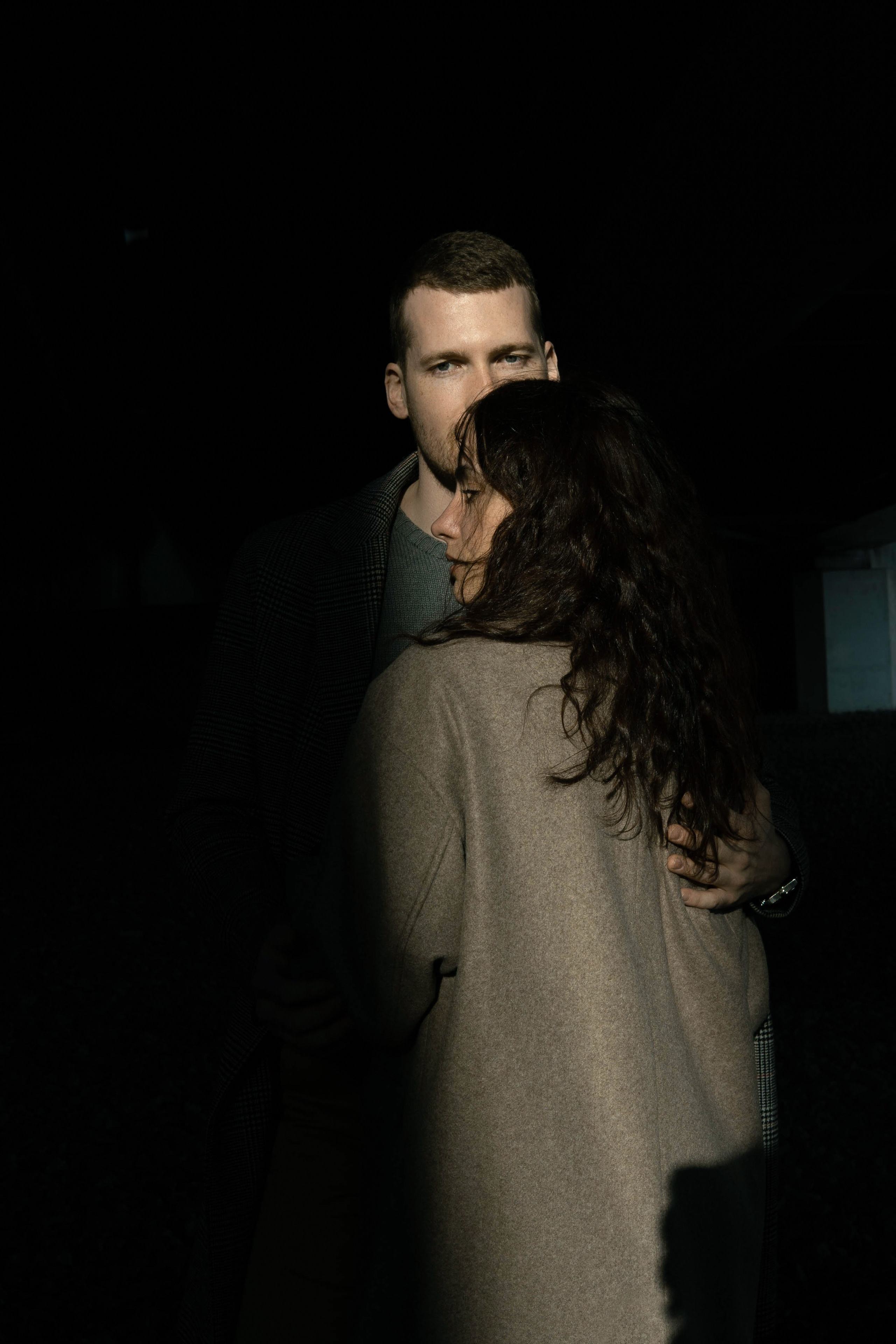 Контрастный портрет влюбленной пары в пальто 