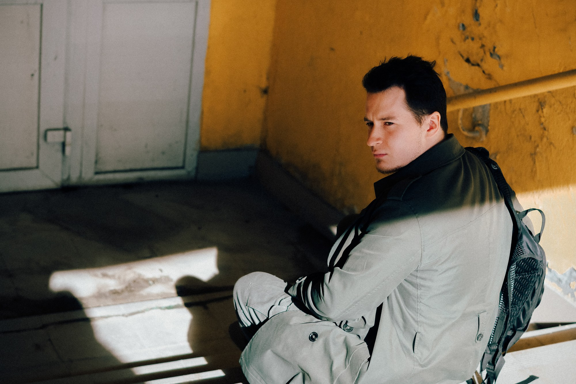 Силуэт человека на лестничной площадке в резких лучах солнца