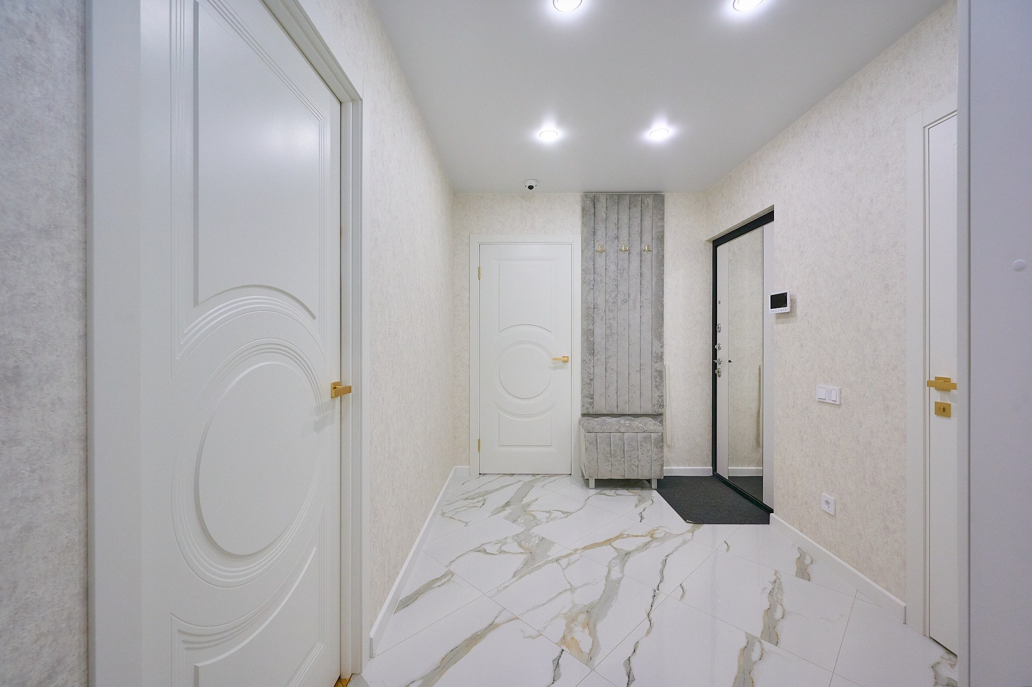 коридор светлые стены и плиты белые двери входная дверь с зеркалом серый пуфик вешалка 