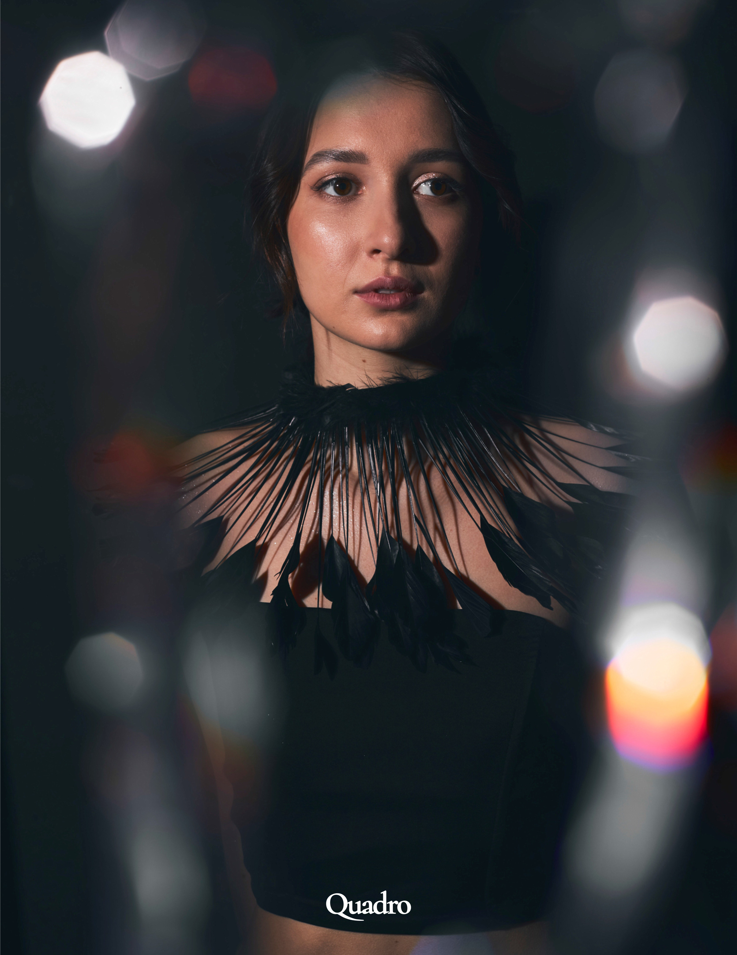 Портрет девушки на тёмном фоне, снятый  сквозь серебристый дождик