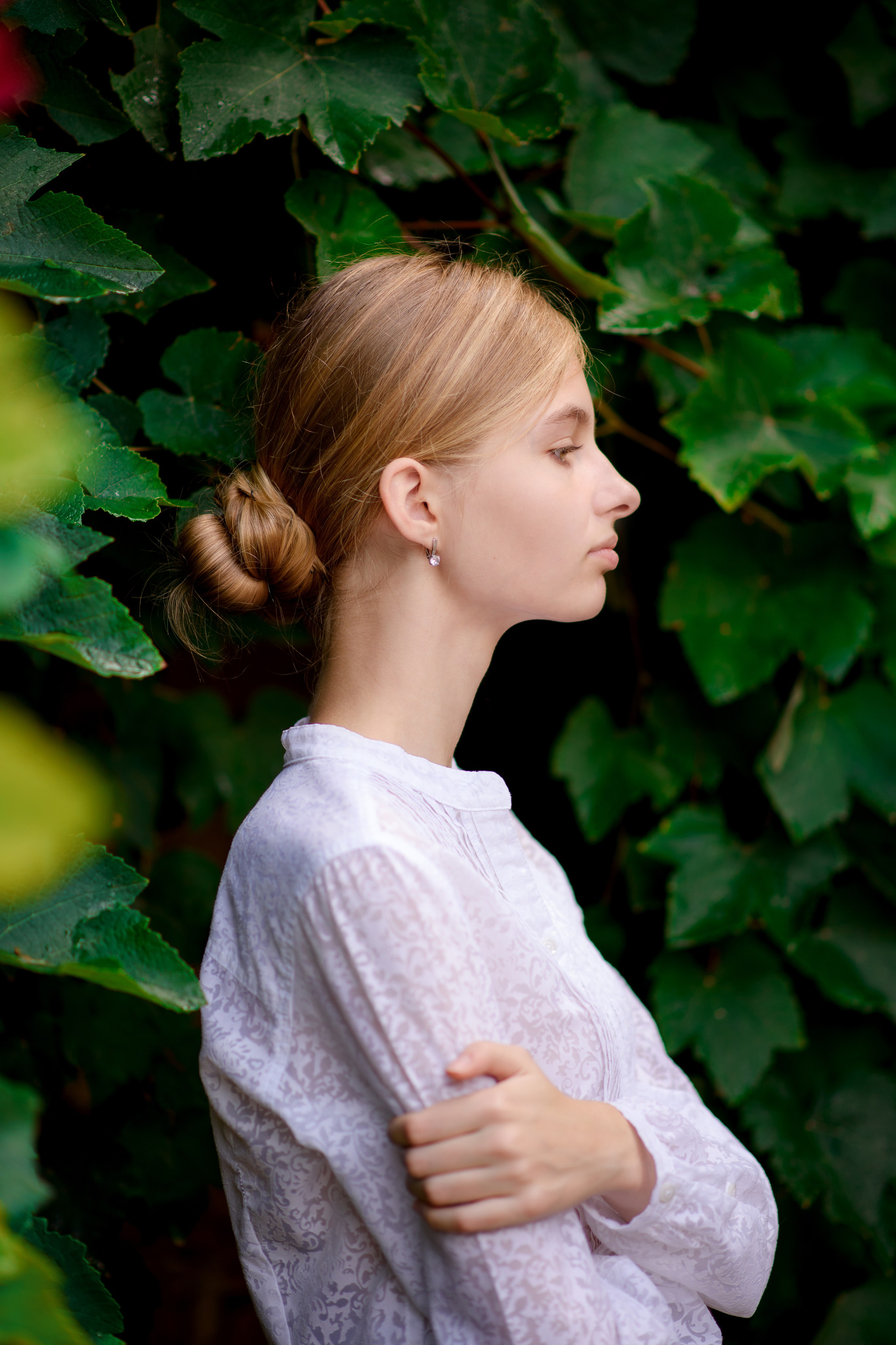 Профиль девочки в зеленых кустах