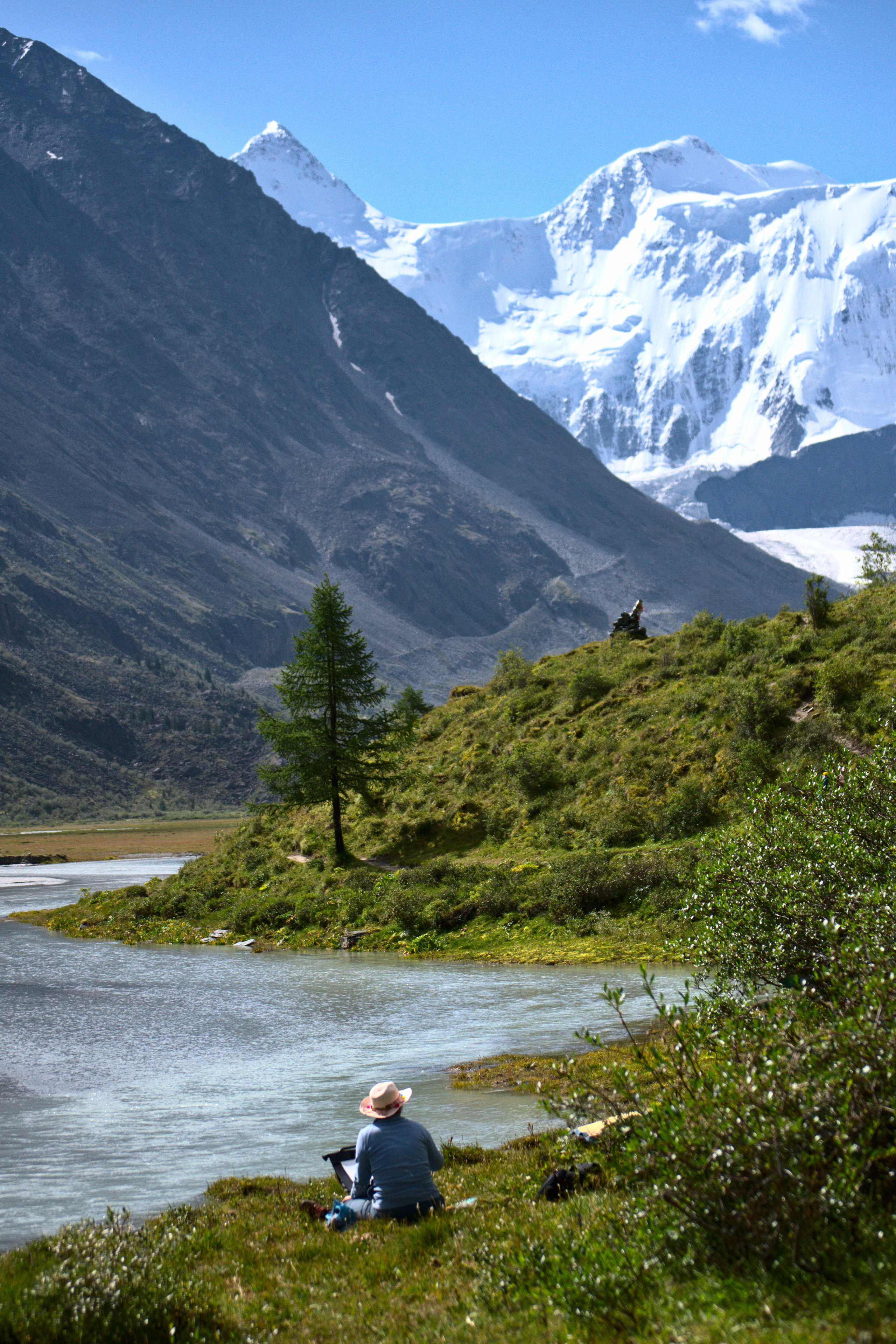 Алтай. Жудожник рисует гору Белуха сидя на аккемском озере. Пейзажная фотография