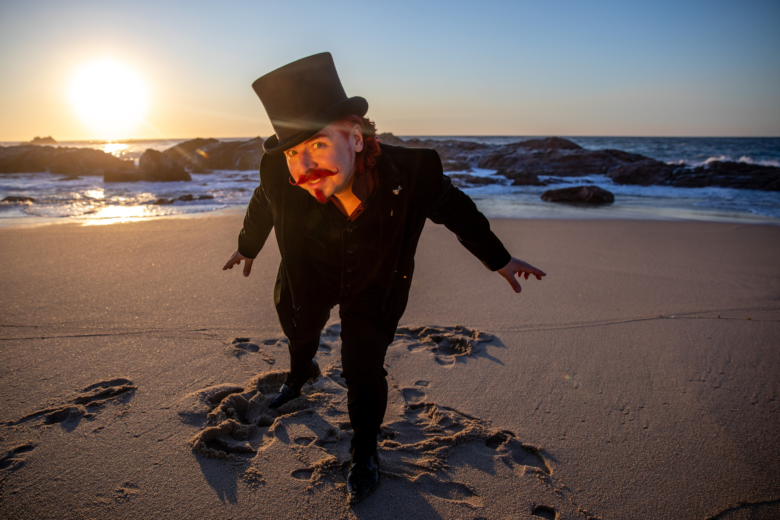 Illusionist and magician walks on the beach and shows tricks