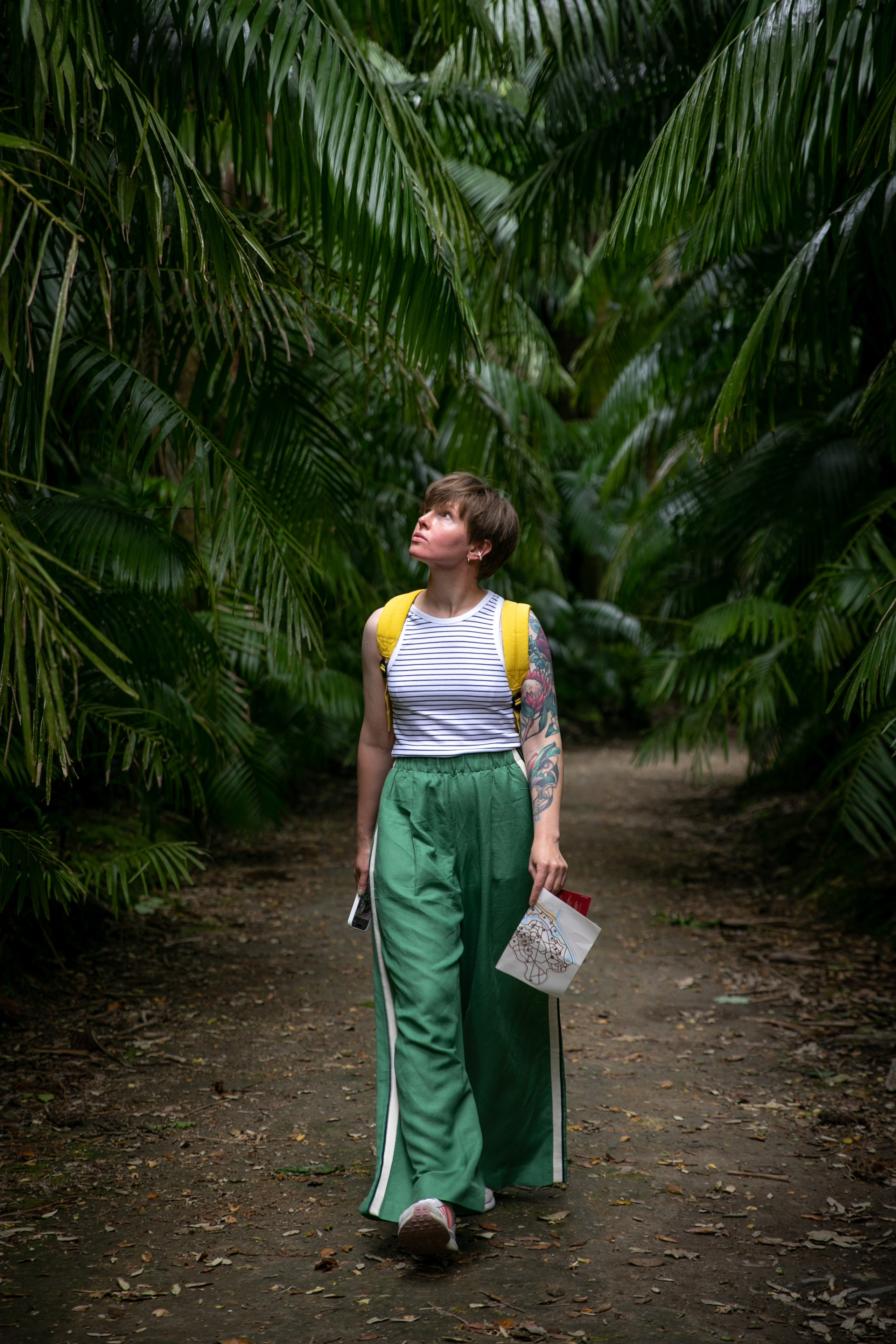 Women wander through the stunning landscapes of the Azores, surrounded by green hills, the ocean, and an open sky above