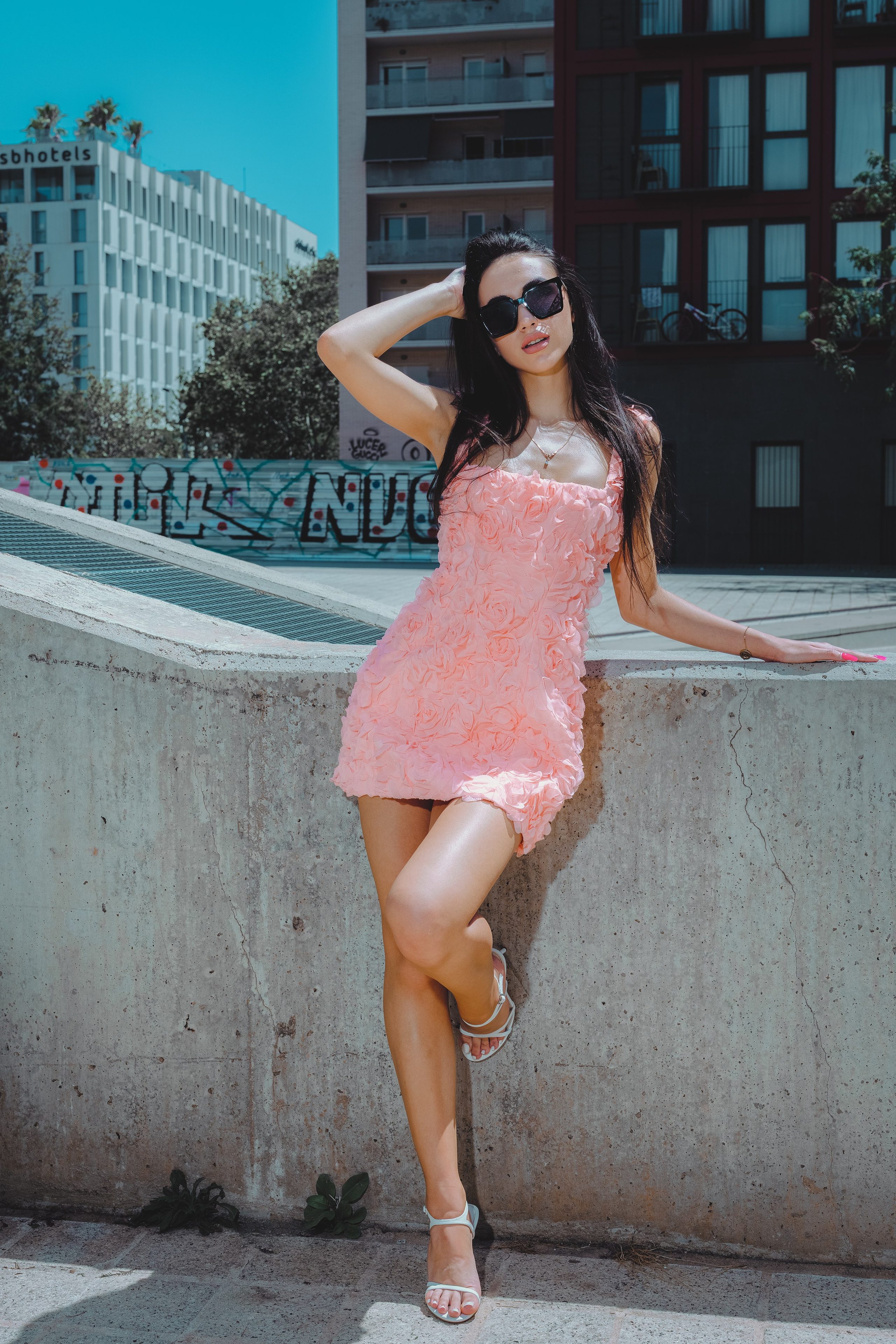 Barcelona city photoshoot with a woman in a delicate rose-colored dress.