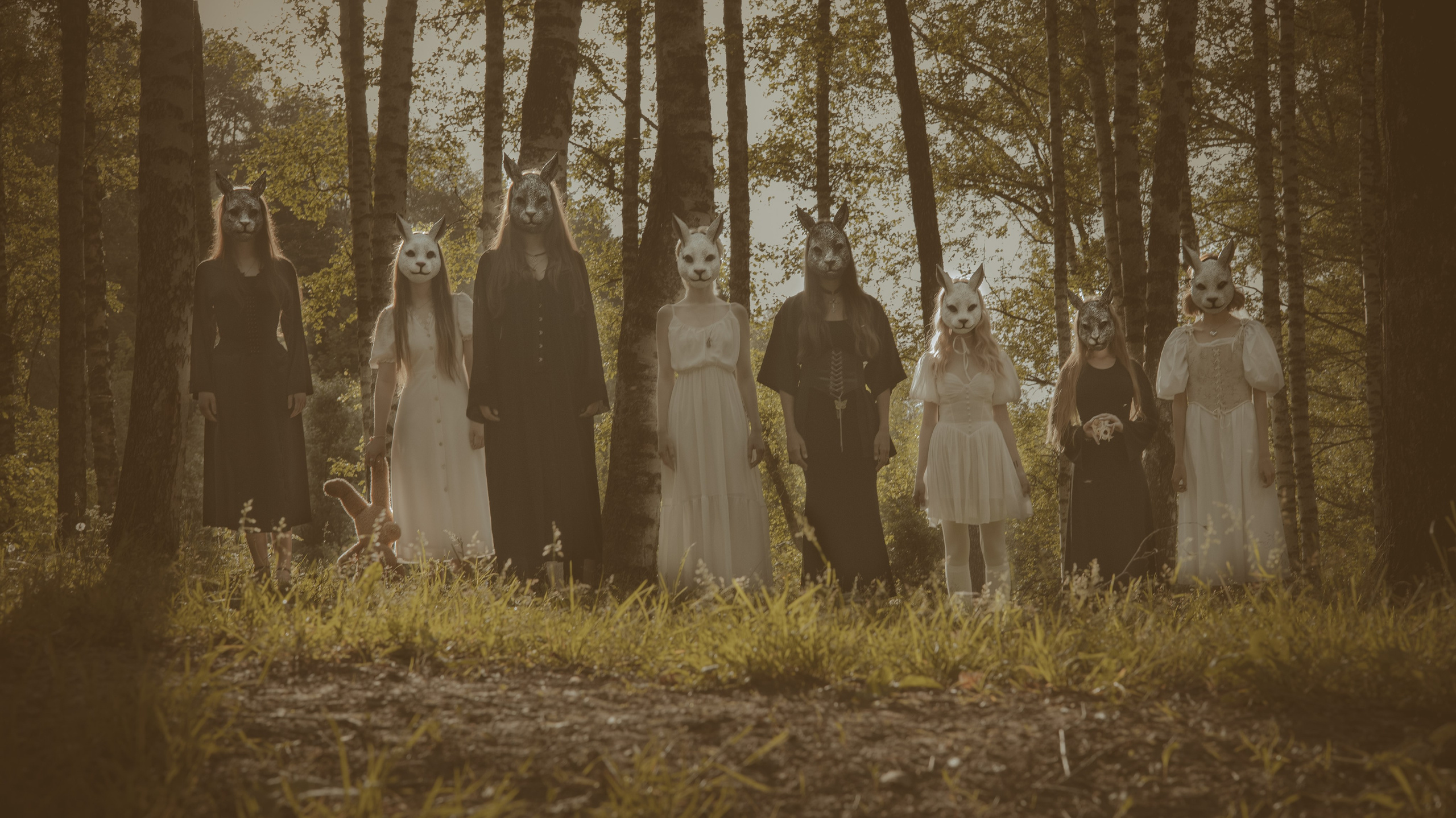 Фотосессия в лесу: группа девушек в масках животных стоит в ряд