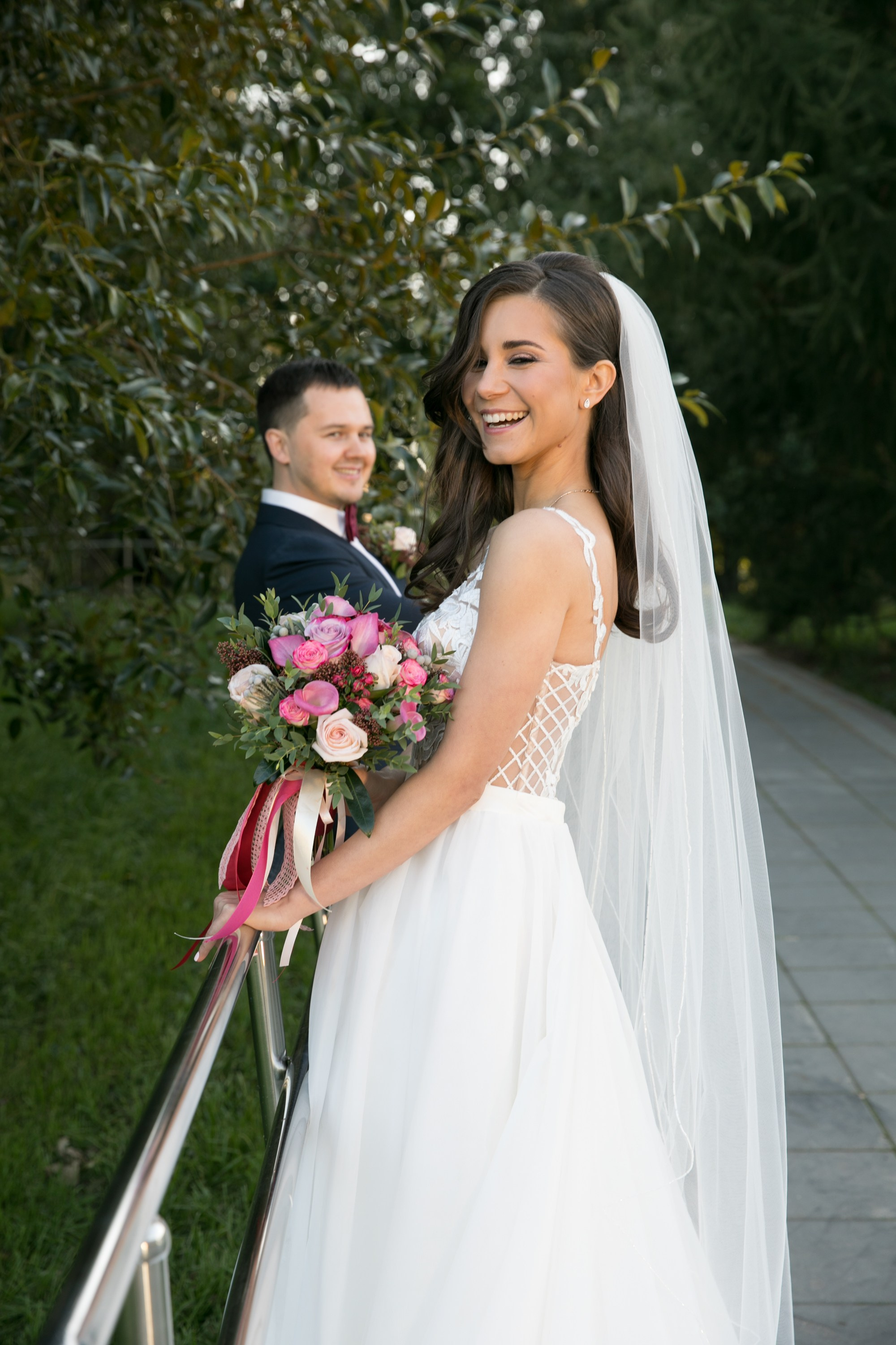 Wedding photo session. Bride in white dress with bouquet in hands. Wedding photographer in Portugal. Oksana Lomnova
