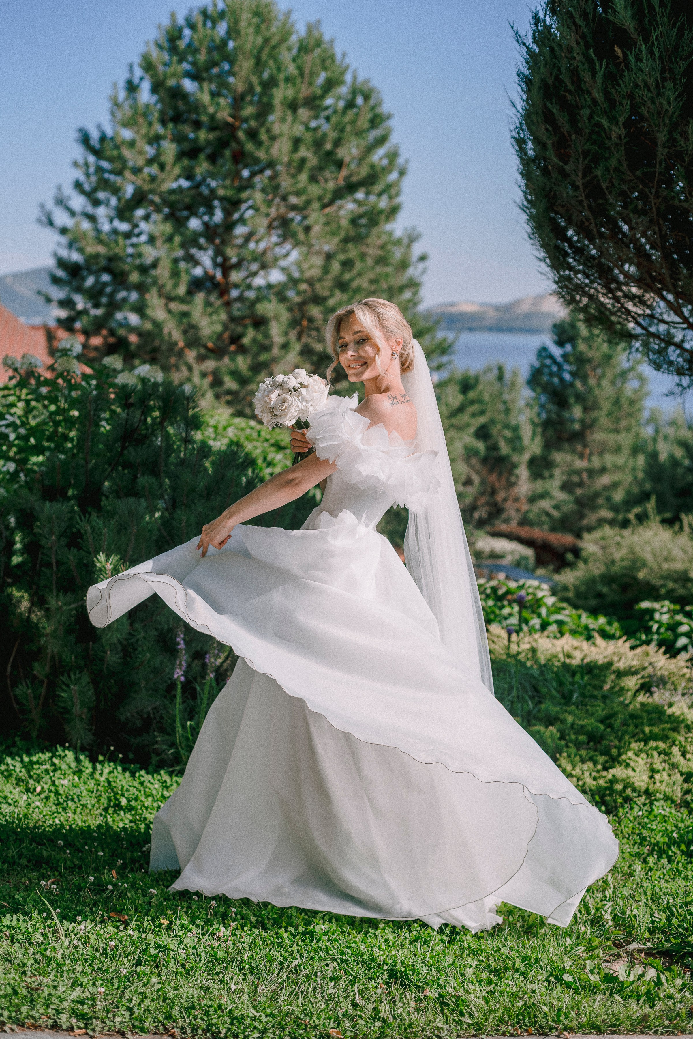 Невеста держится за платье и крутится