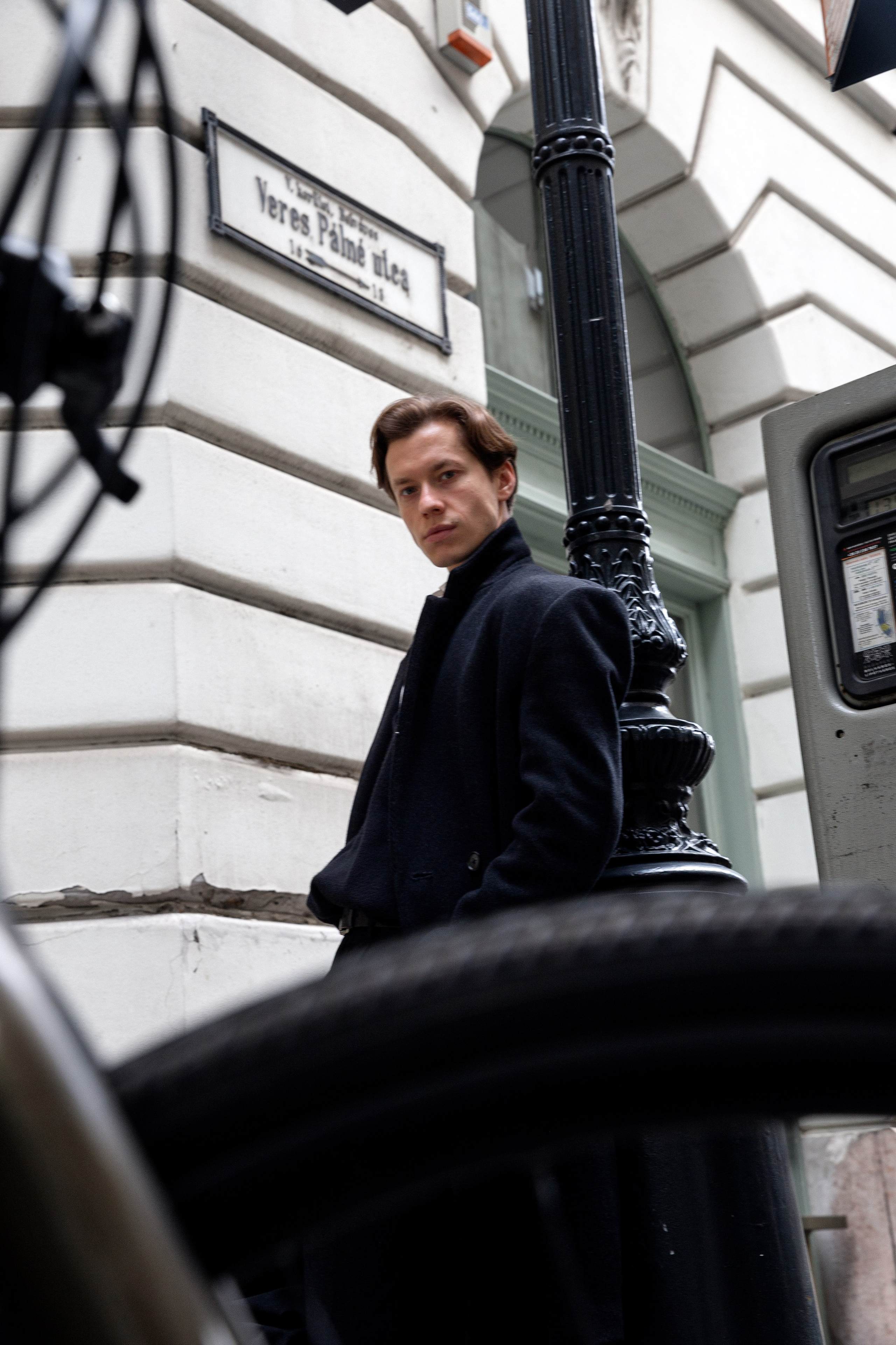 a man's photo in front of the White House in Budapest