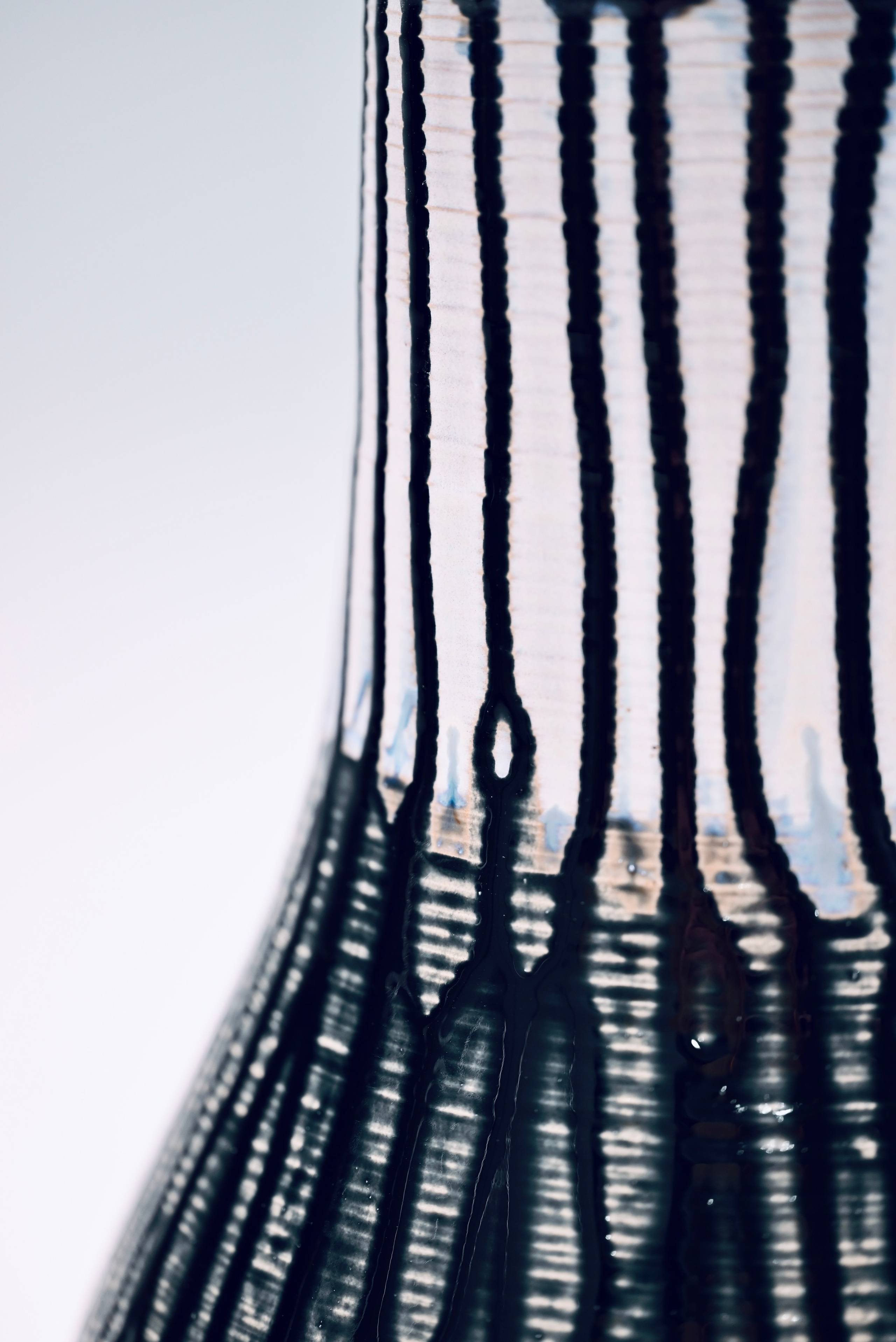 Сосуд «Зольник». 2024. Этот сосуд вырос из печного сезона. Всю зиму мастерская жила на дровах — ель, сосна, берёза — каждая полешка оставляла за собой золу. Не выносить её, не выбрасывать, а восстановить — в этом был вызов. Так родилась глазурь: из пепла древесины, сожжённой ради тепла и ремесла, — и нанесена на форму, выточенную в том же дыхании.«Зольник» — это второе тело леса, пережитого в огне. Это не сосуд для золы, а сосуд из золы — он не хранит, он говорит. Рисунок на поверхности — как дождь в выжженной роще, или как древесная кора, на которой запеклось солнце.Это работа о тепле, которое требует жертвы. О памяти леса, пущенного в топку. О том, как прах дерева может стать золотом.