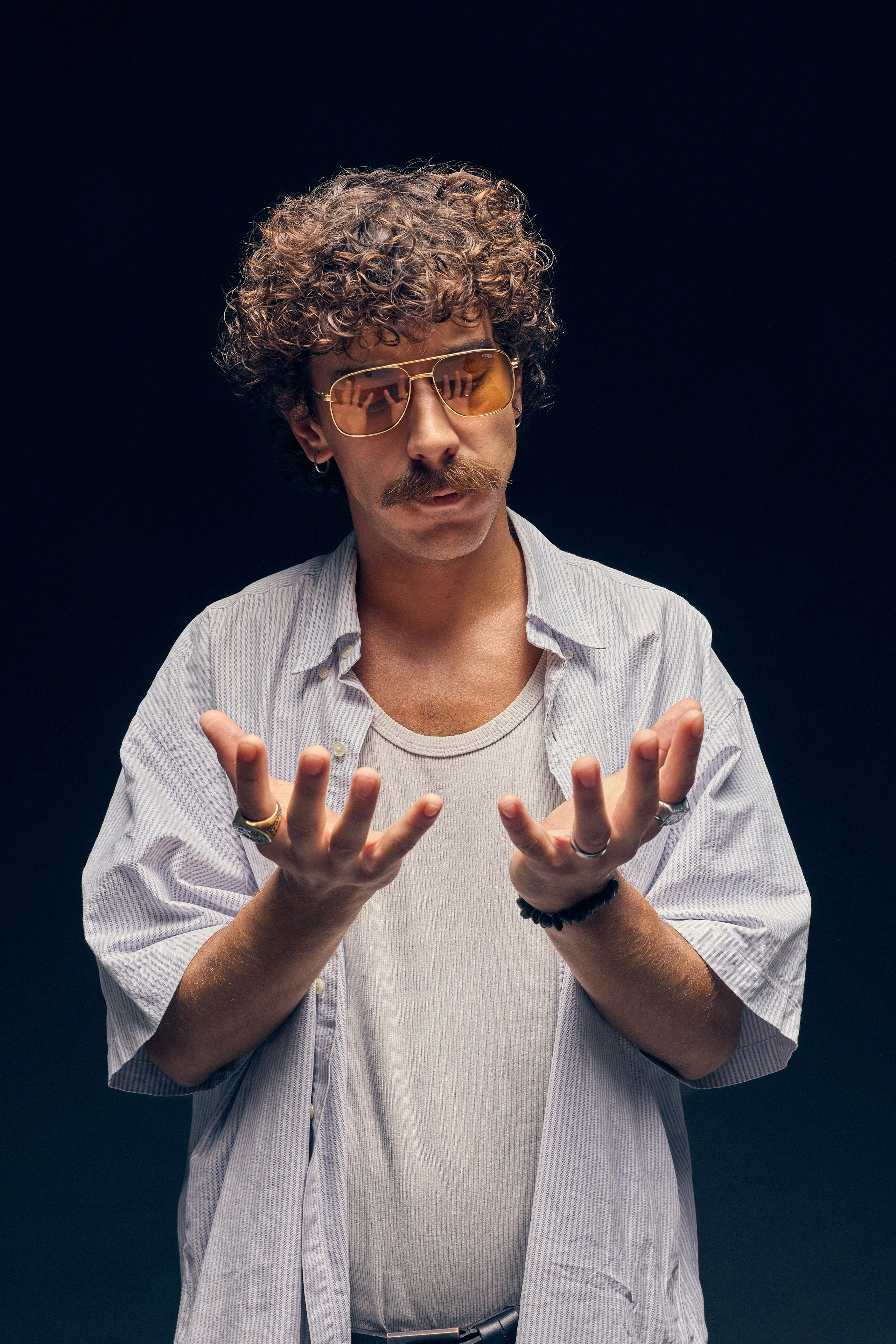 Man with mustache and orange tinted glasses posing with flour for cooking theme