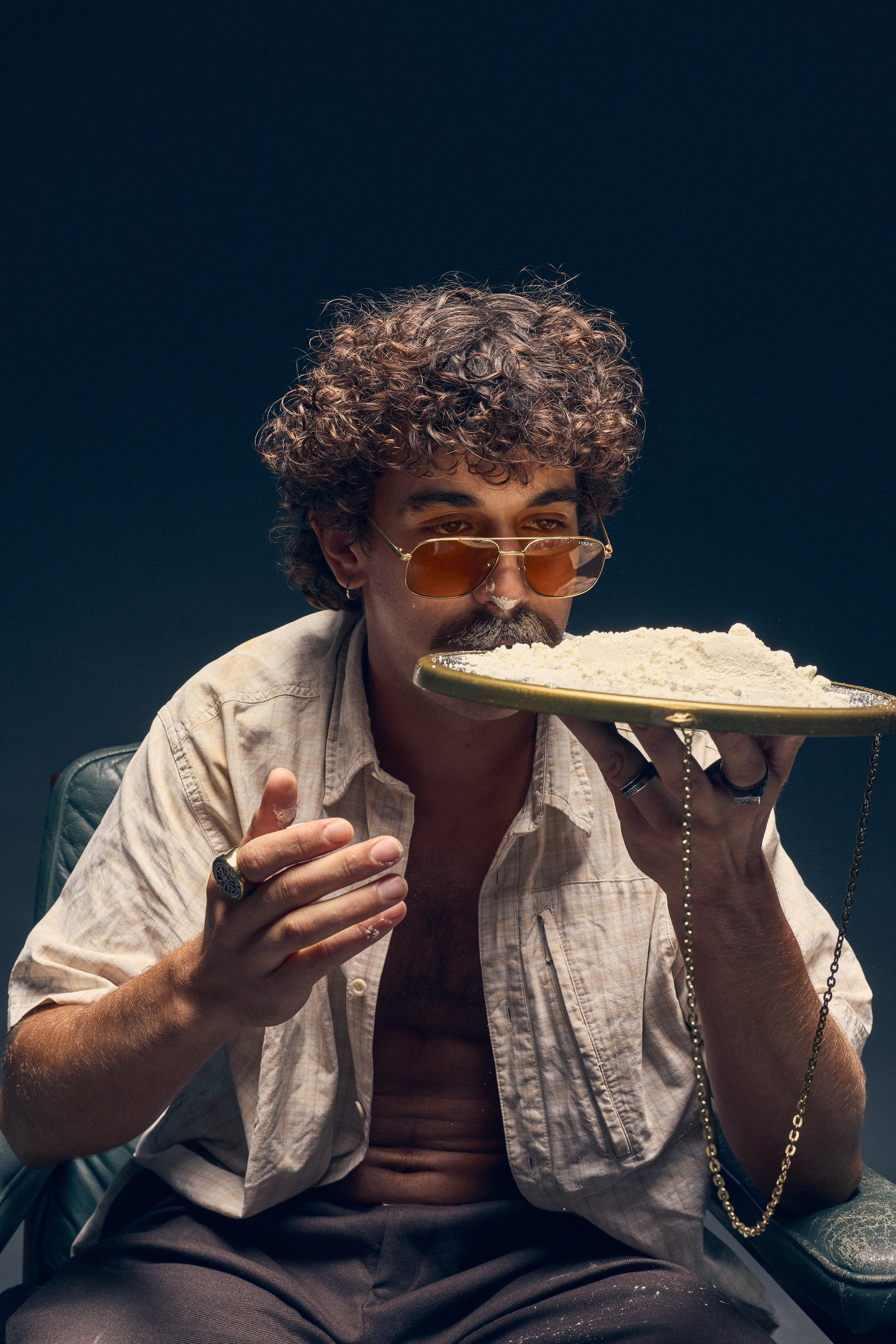 Studio retro fashion portrait of male model in chair