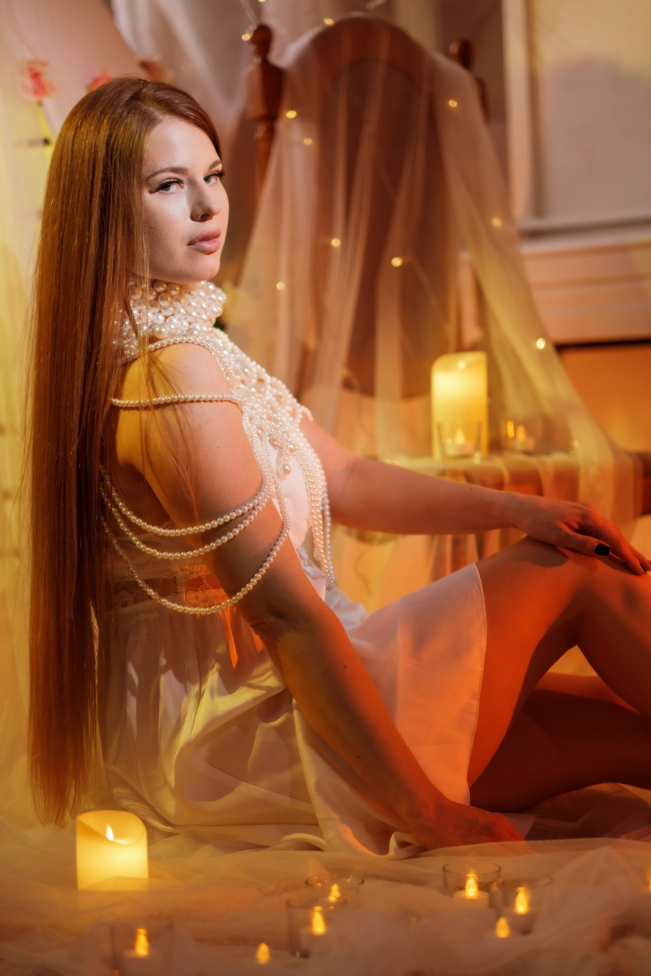 Девушка с окружении свечей и гирлянд