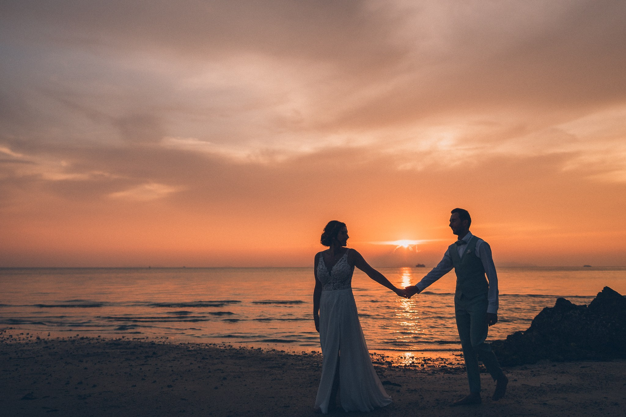 Wedding celebration with guests on a tropical sunset beach in Koh Samui
