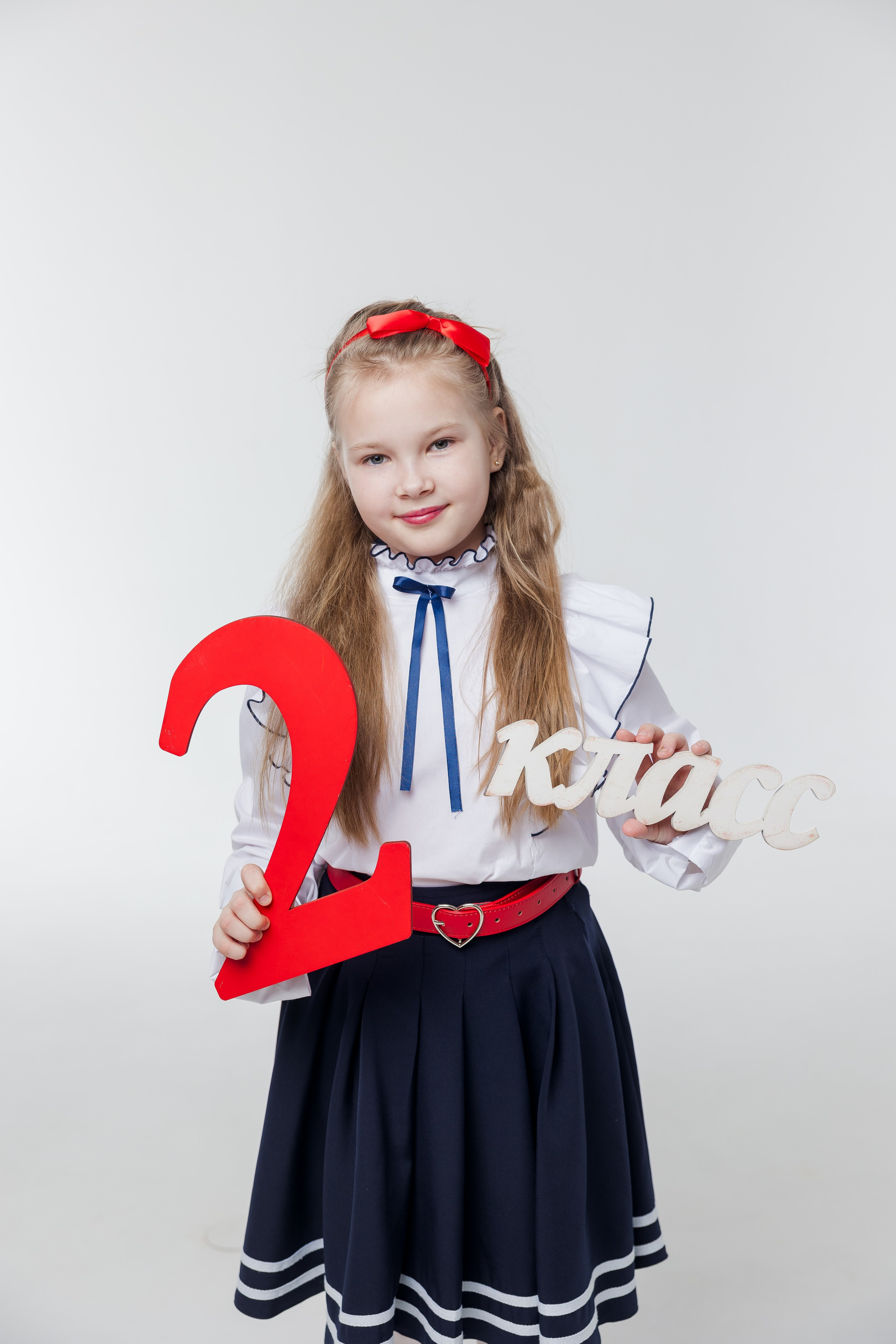 Портрет девочки в студии с надписью второй класс