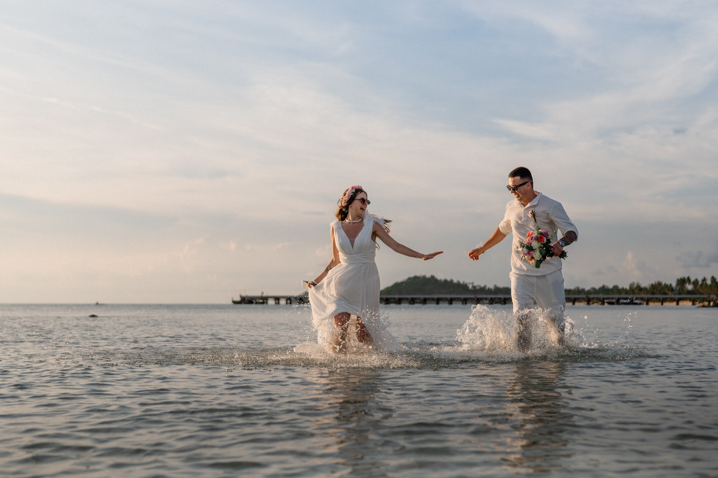 Bride and groom exchanging vows on a private sunset beach
