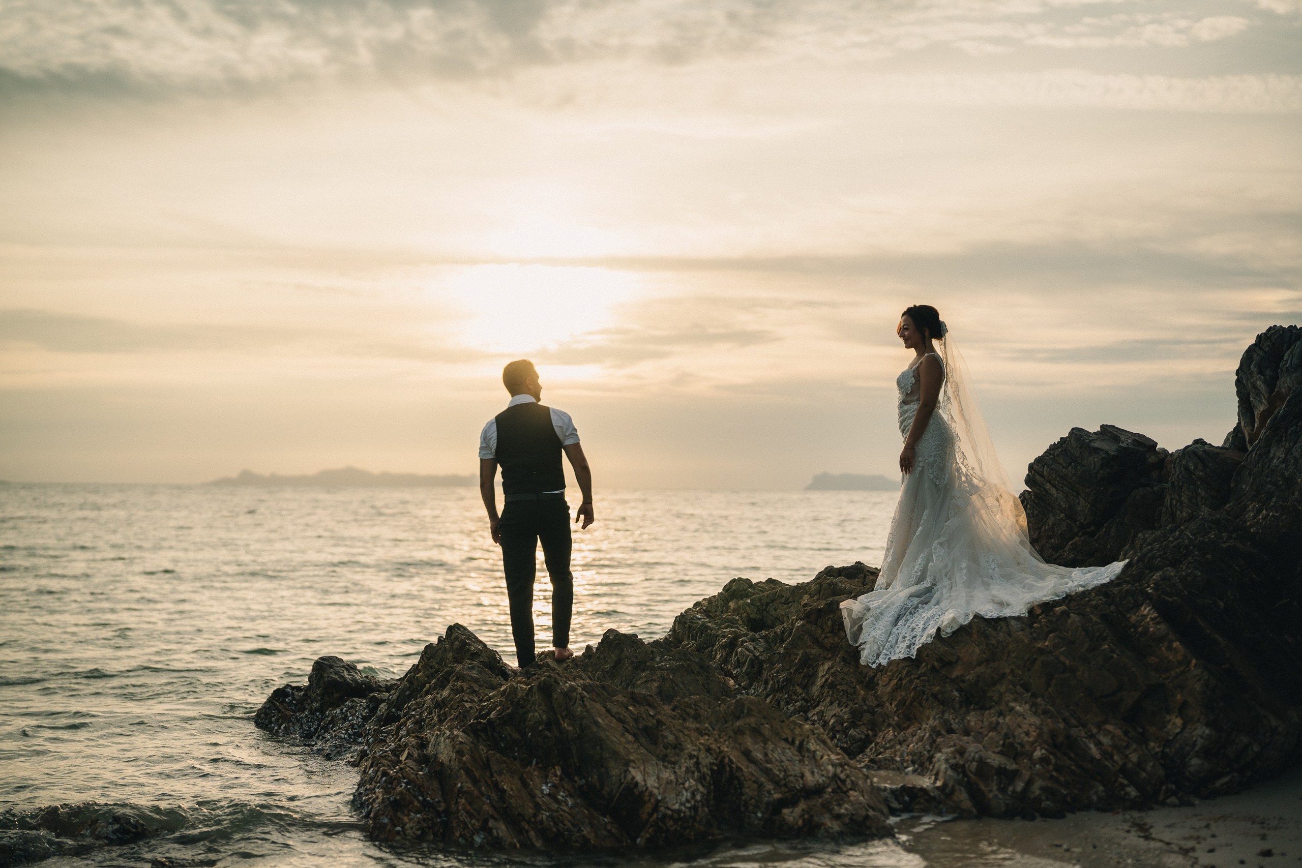 Bride and groom celebrating a beach wedding with their children in Koh Samui, Thailand, surrounded by tropical scenery and ocean views