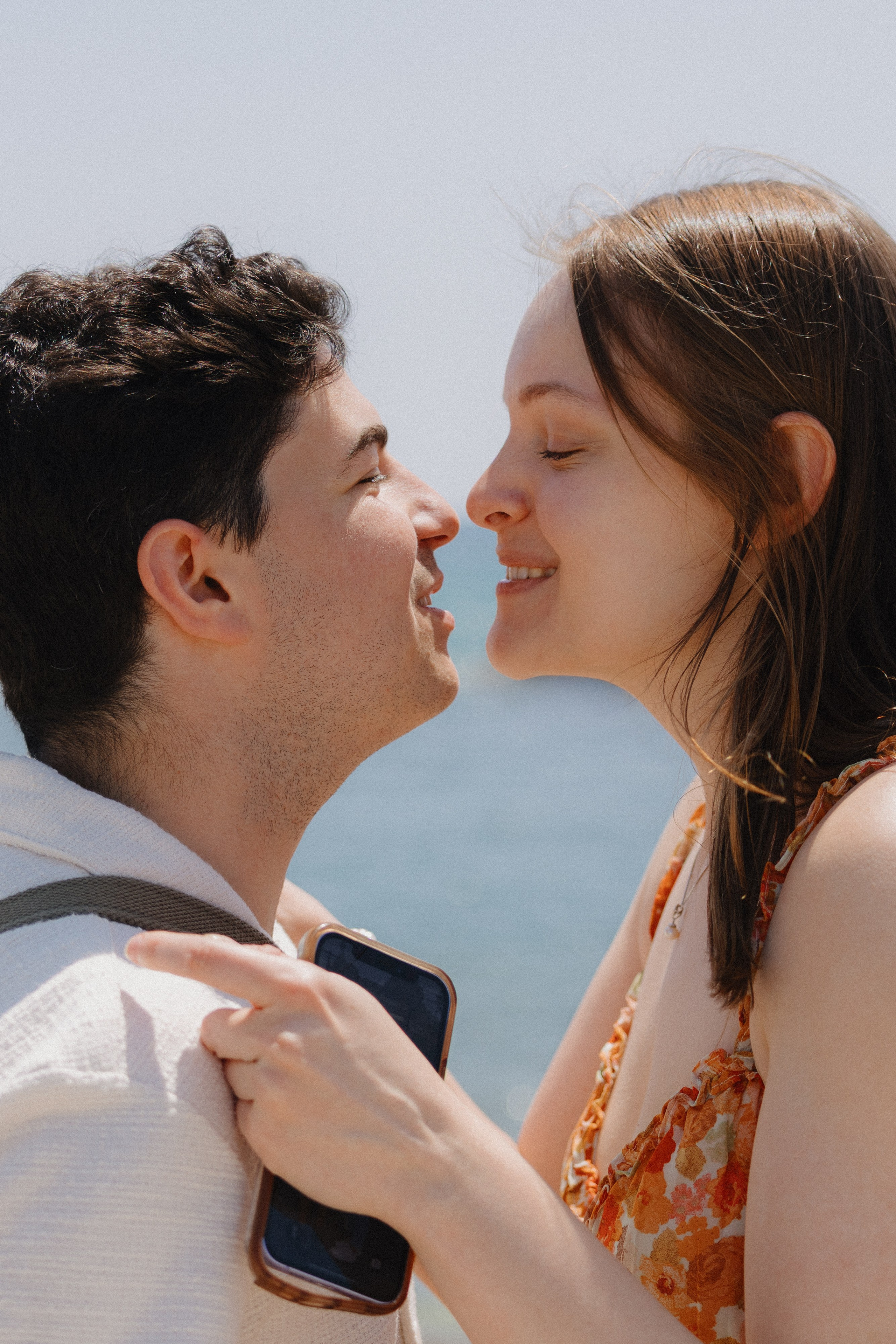 Couple hugging after saying yes on a scenic rooftop