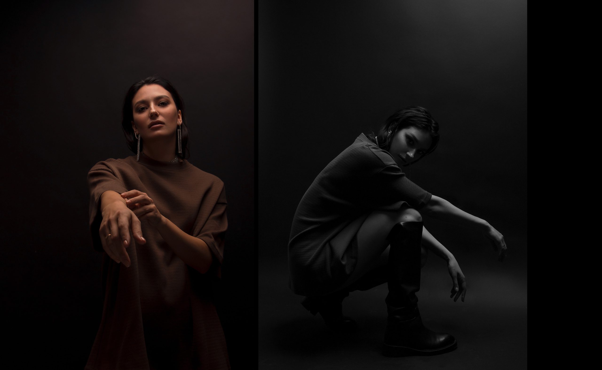 Девушка в полумраке сидит на корточках и протягивает руки к камере.