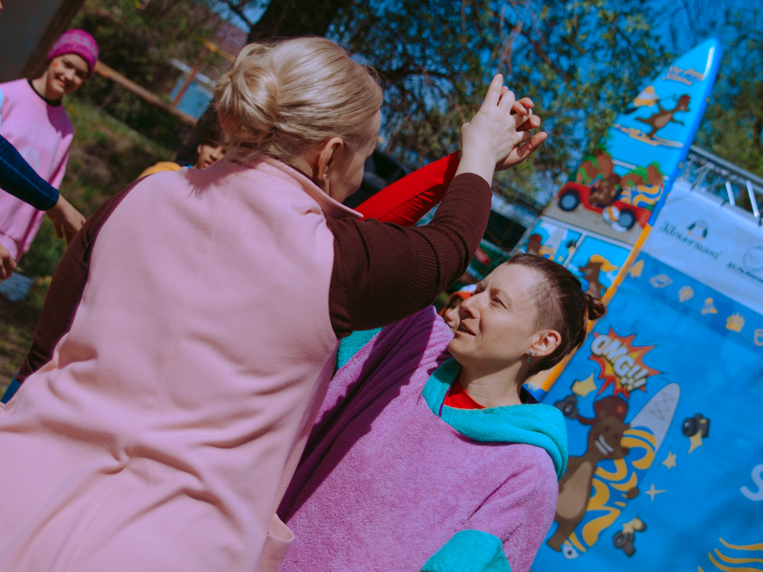 Женщины держатся за руки.