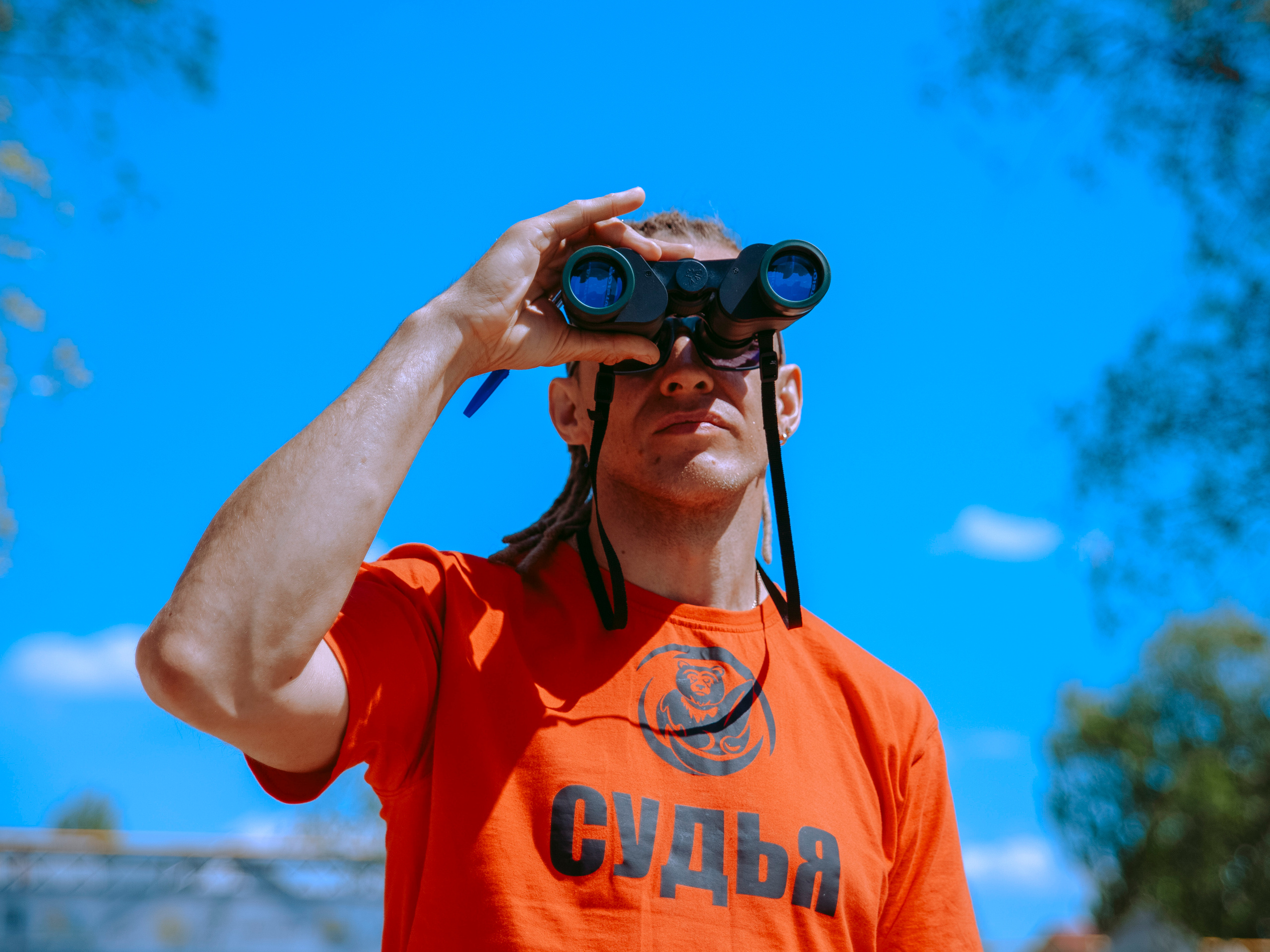 Судья смотрит в бинокль.