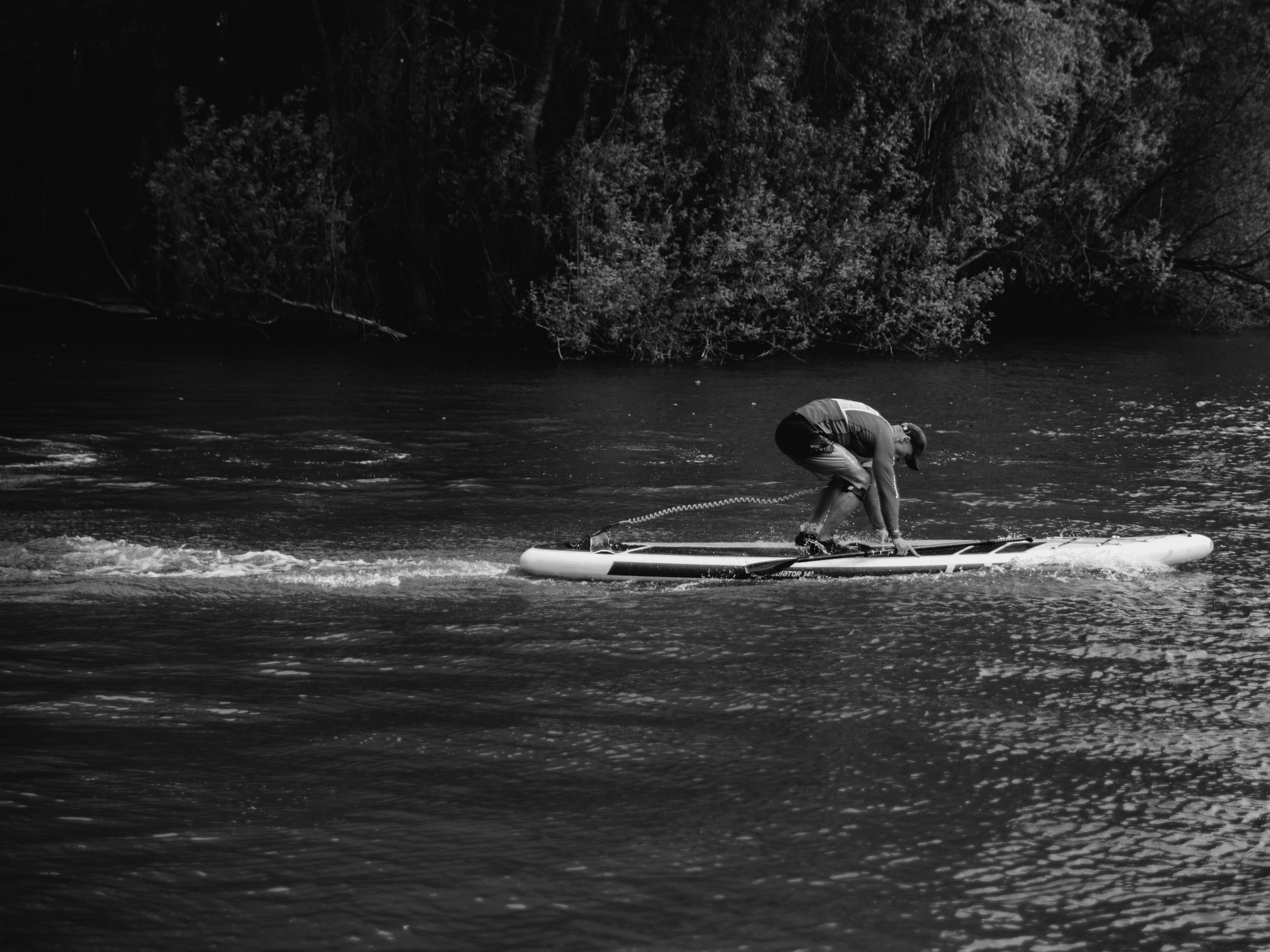 Мужчина серфер запрыгивает на доску.