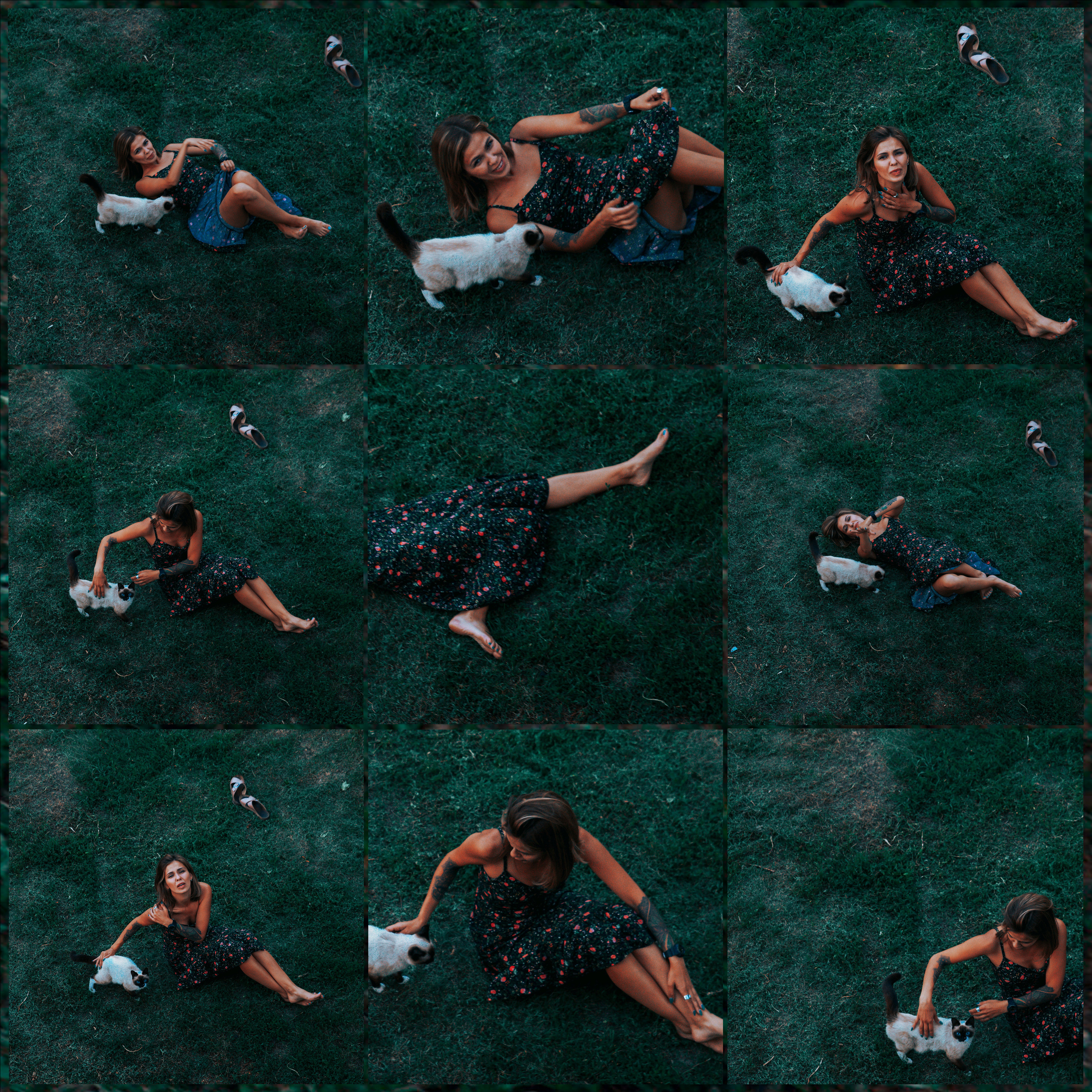 Девушка в сарафане с цветочным принтом лежит на зеленой траве и играет с котами.