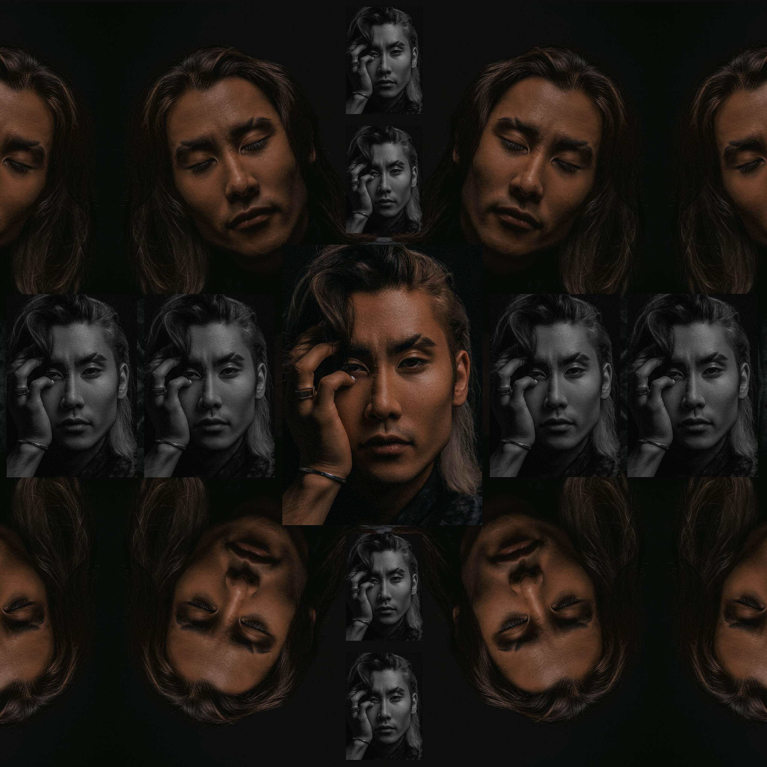 Портрет мужчины корейца с закрытыми глазами и рукой у лица.