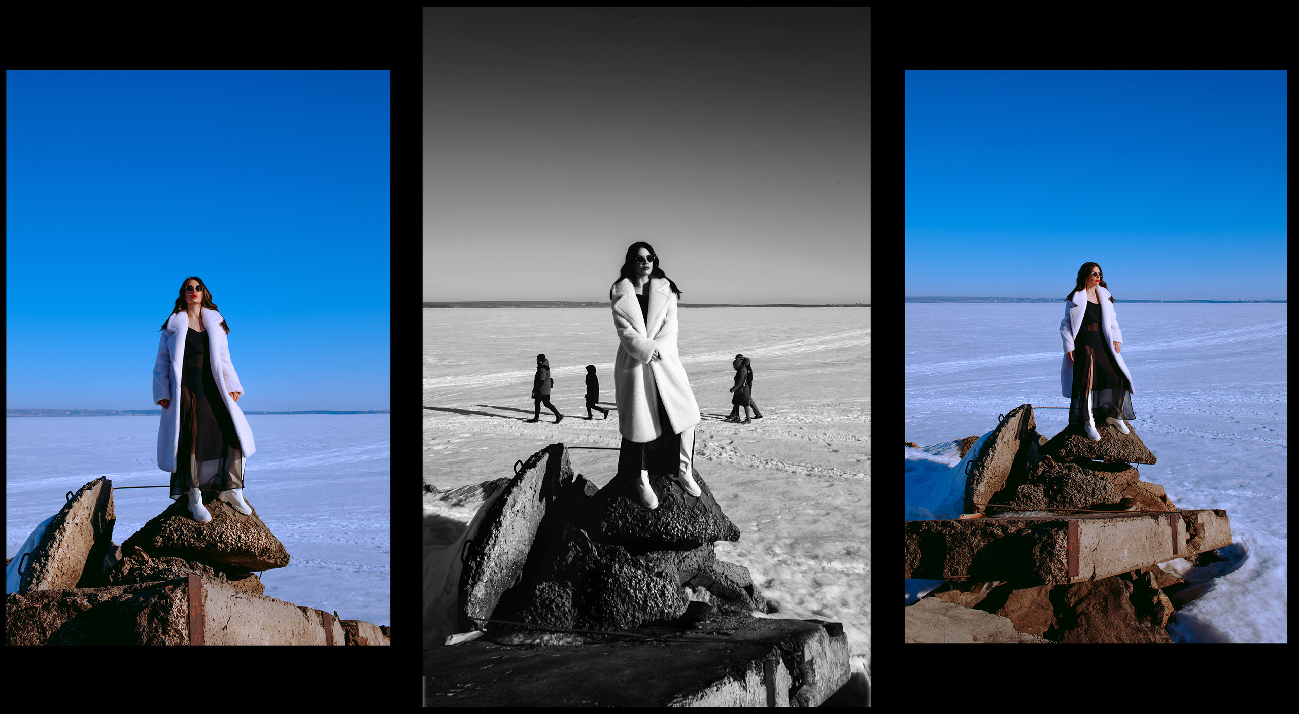 Девушка с темными волосами в белой шубе на камнях на фоне снега и людей.