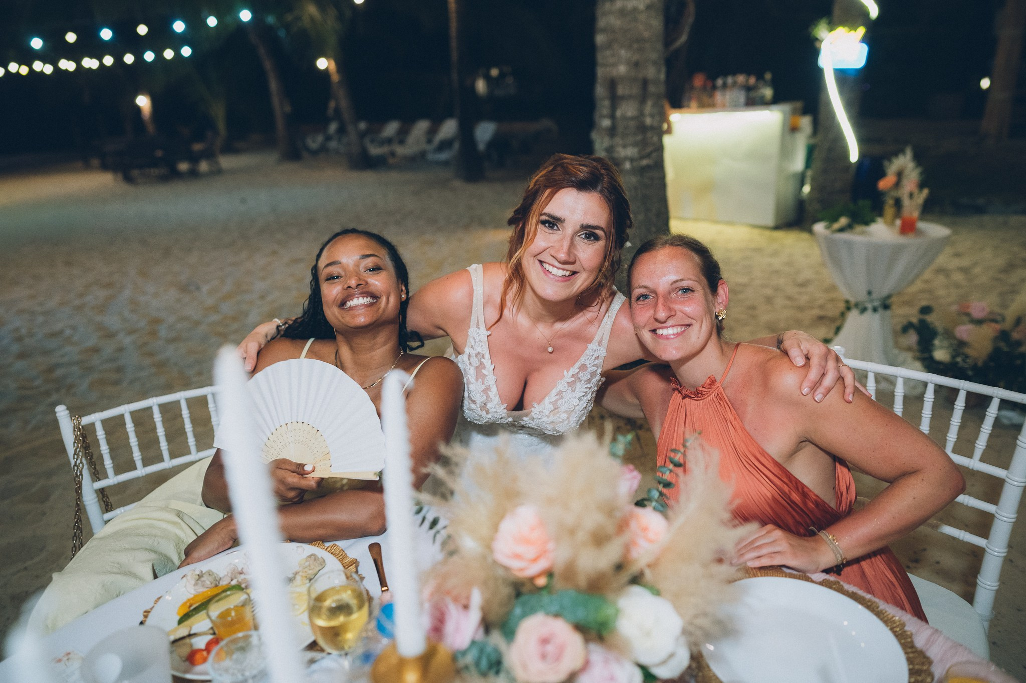 Wedding celebration with guests on a tropical sunset beach in Koh Samui