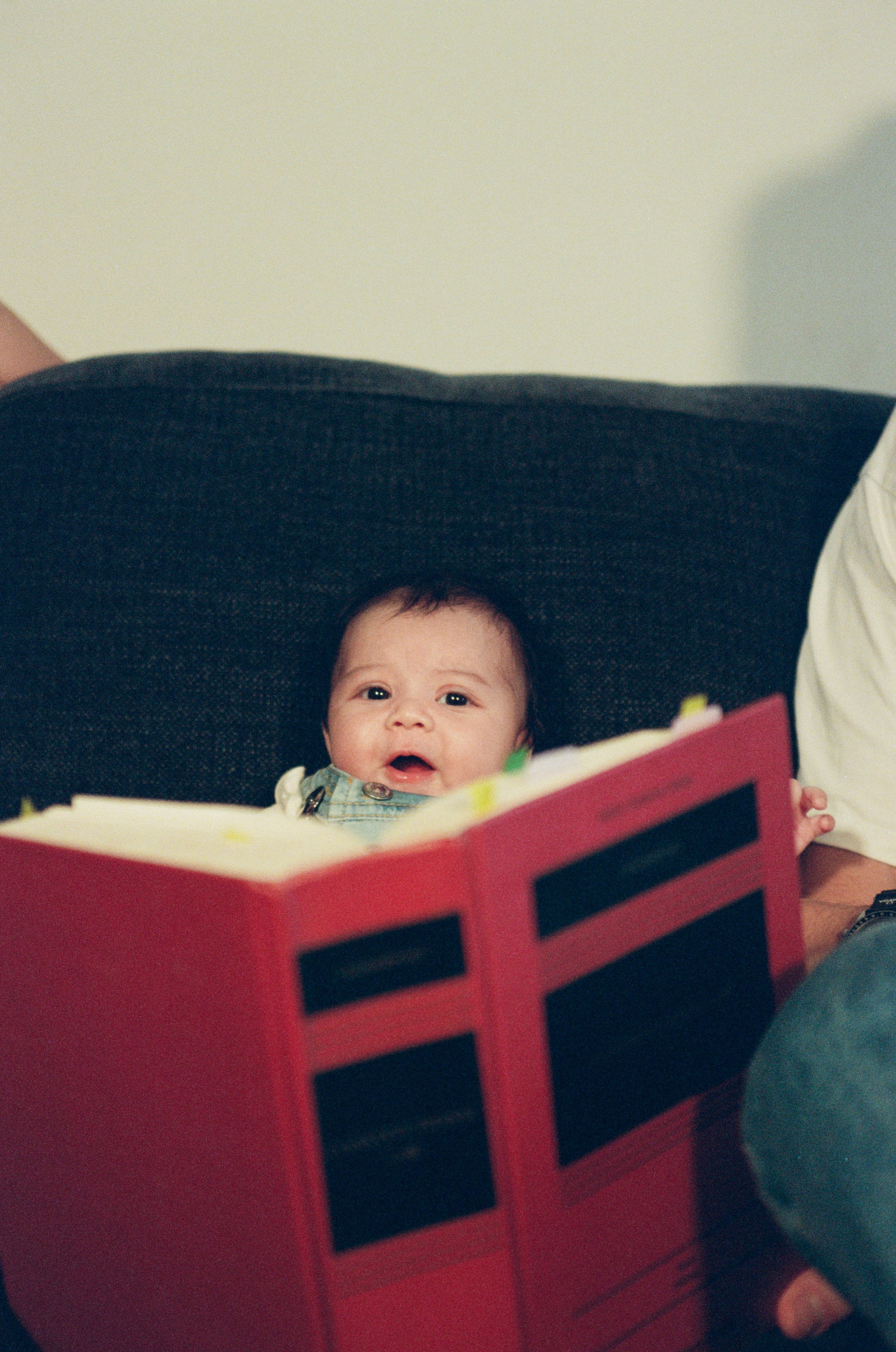a newborn baby of two layers already reading a huge law book a fun lifestyle session