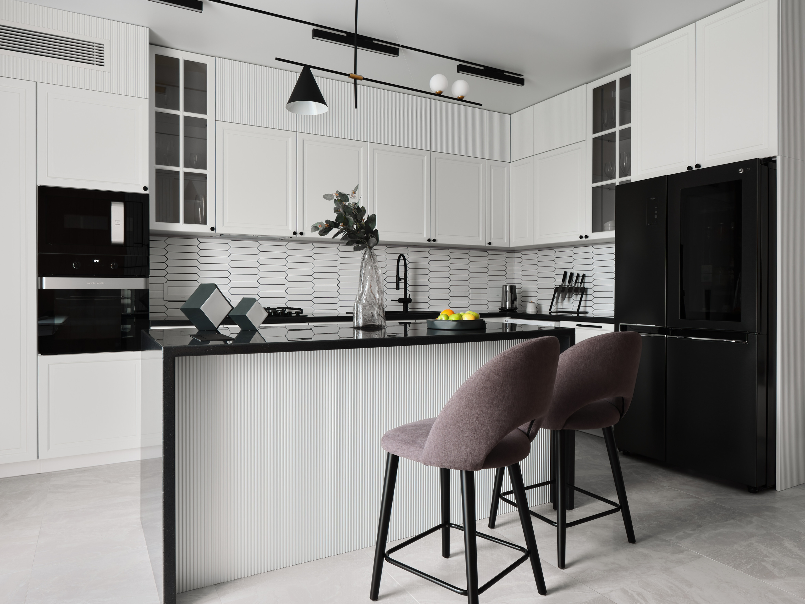 Современная кухня в светлых тонах с акцентом на черную технику, барные стулья и дизайнерское освещение. Стильный интерьер от дизайнера Анжелики Исаевой, интерьерная фотосъемка Сергея Денисенко, гармония минимализма и функциональности.