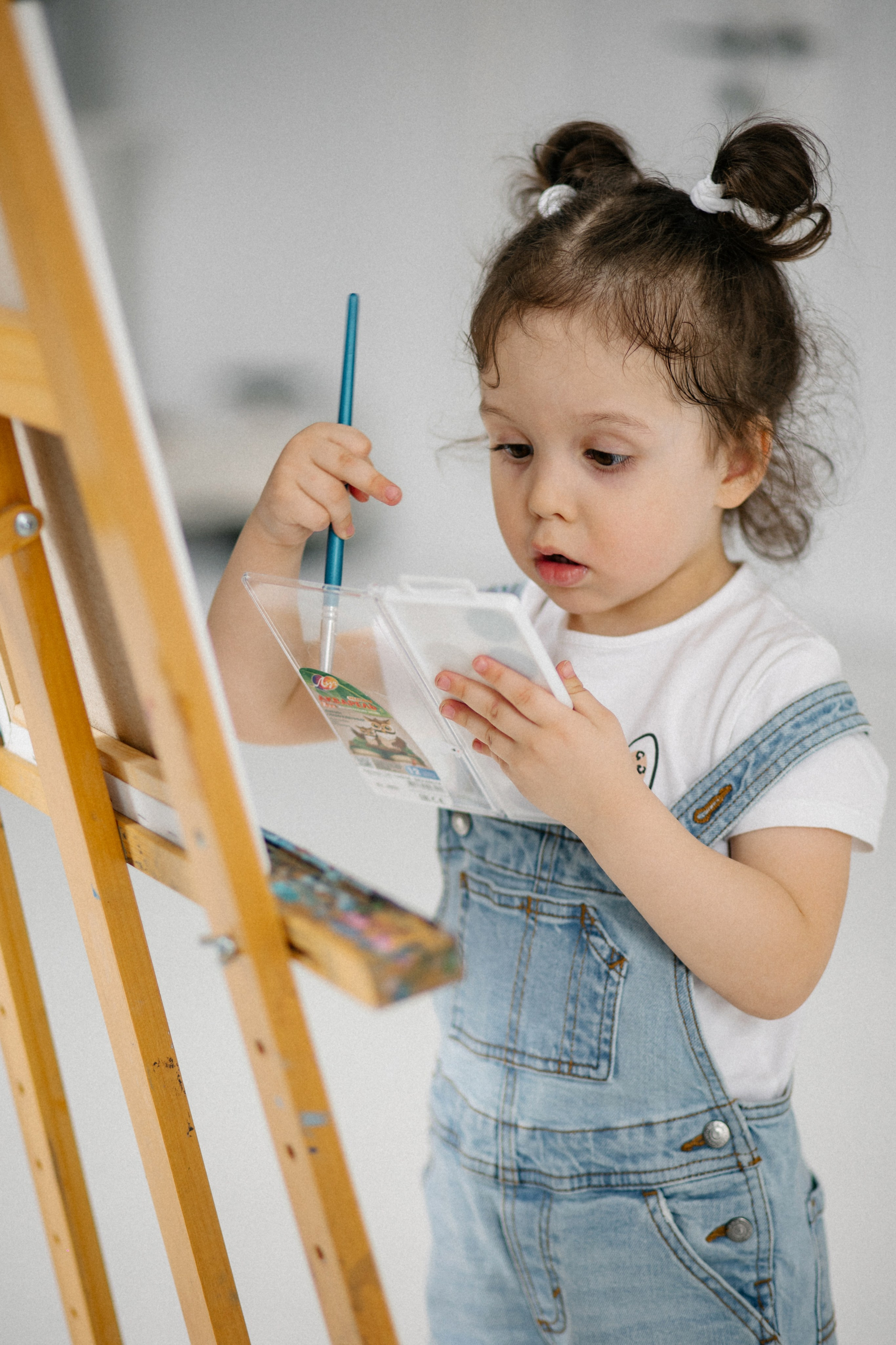 море эмоций на лице ребенка от красок и мольберт 