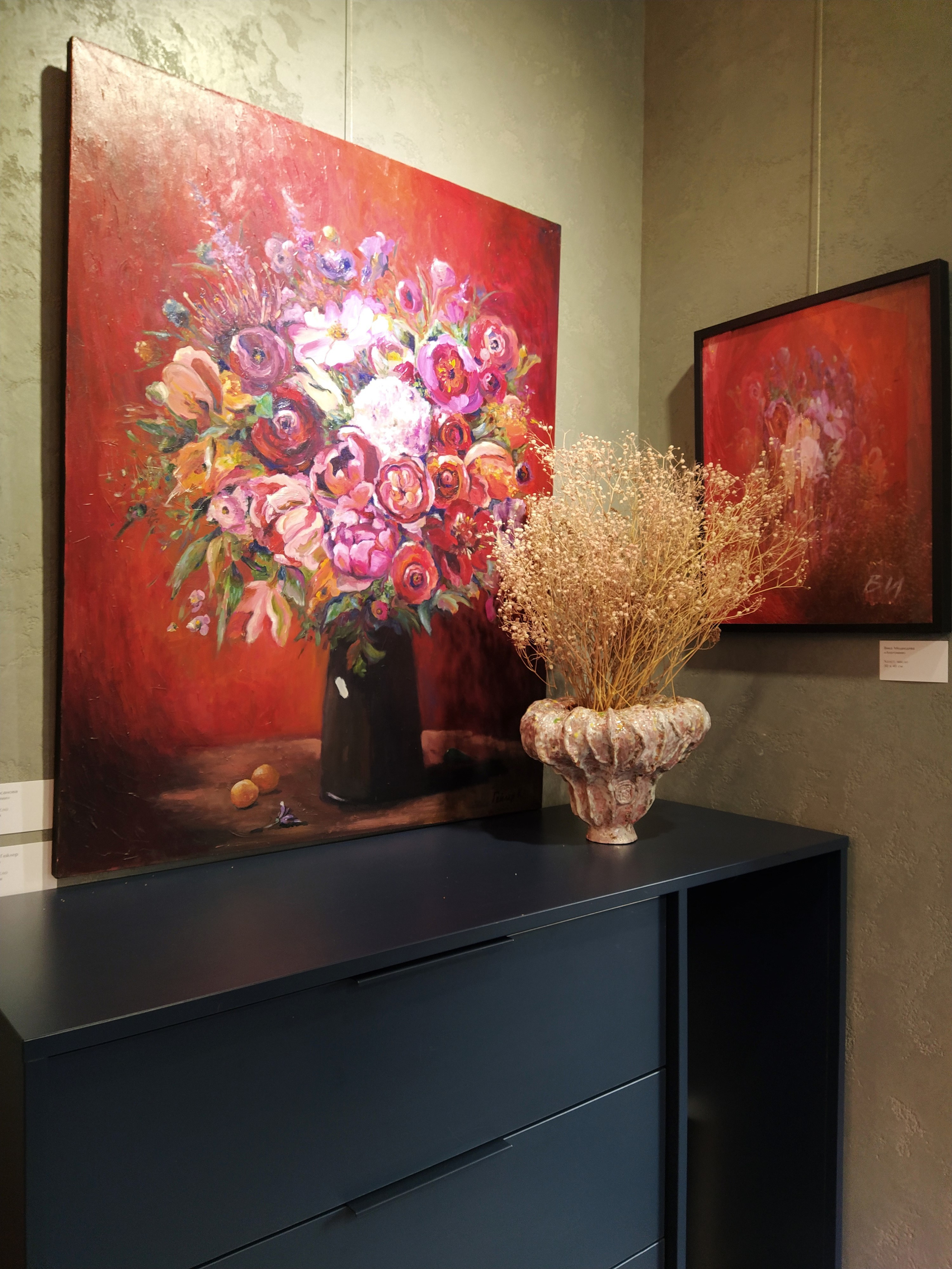 Керамическая ваза рядом с красной картиной