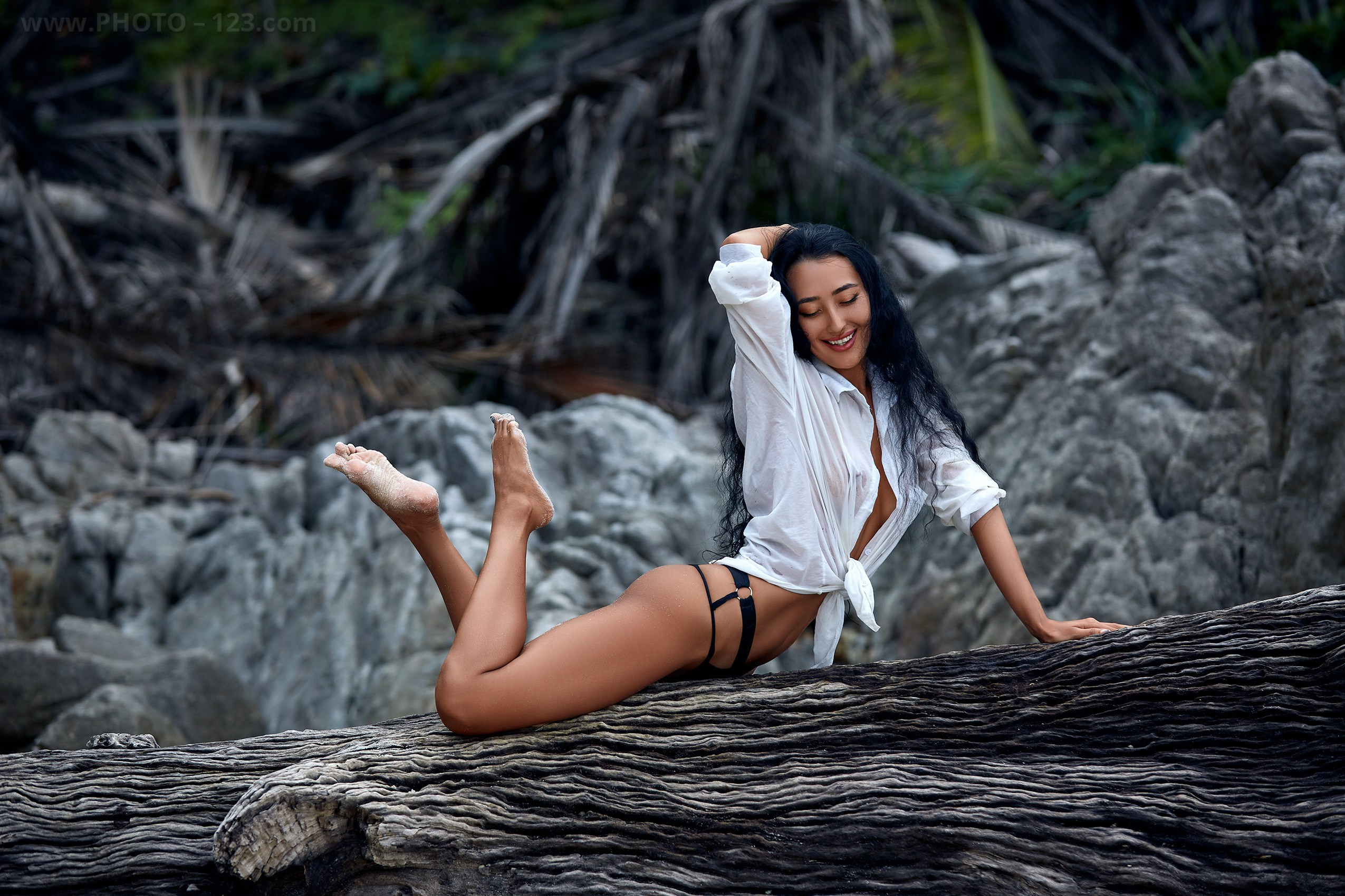 Artistic editorial portrait on a massive driftwood log, captured by a professional photographer with 25 years experience.