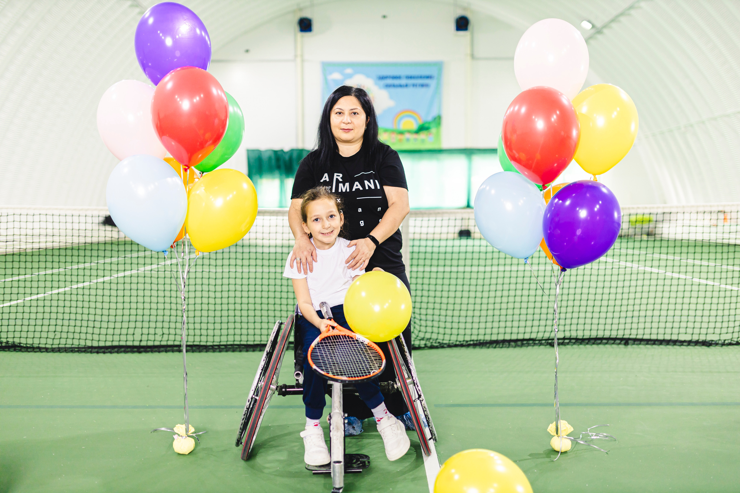 радостные дети с воздушными шариками на колясках