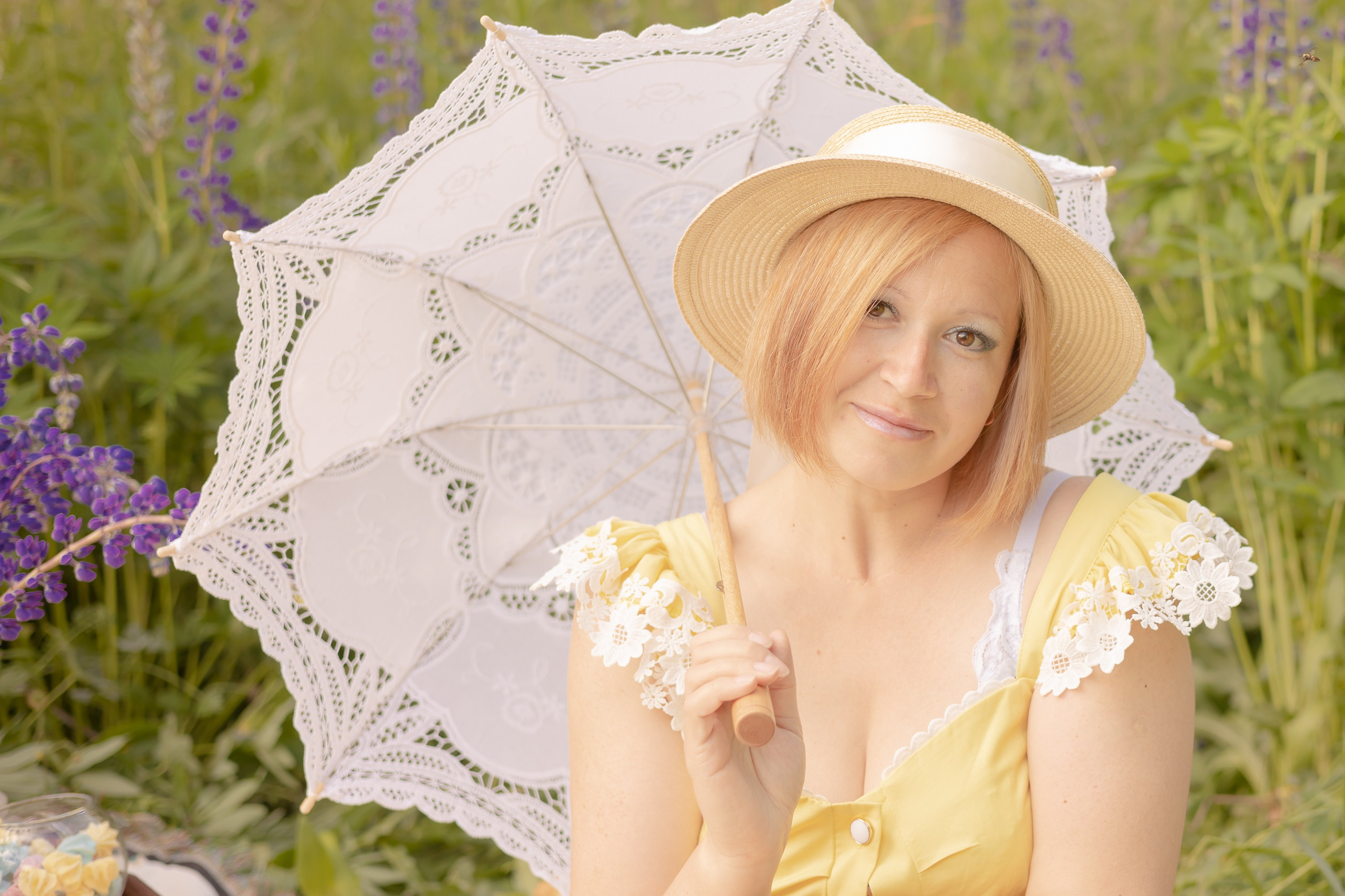 Женщина в соломенной шляпке, небрежно опустила на плечо ажурный белый зонт
