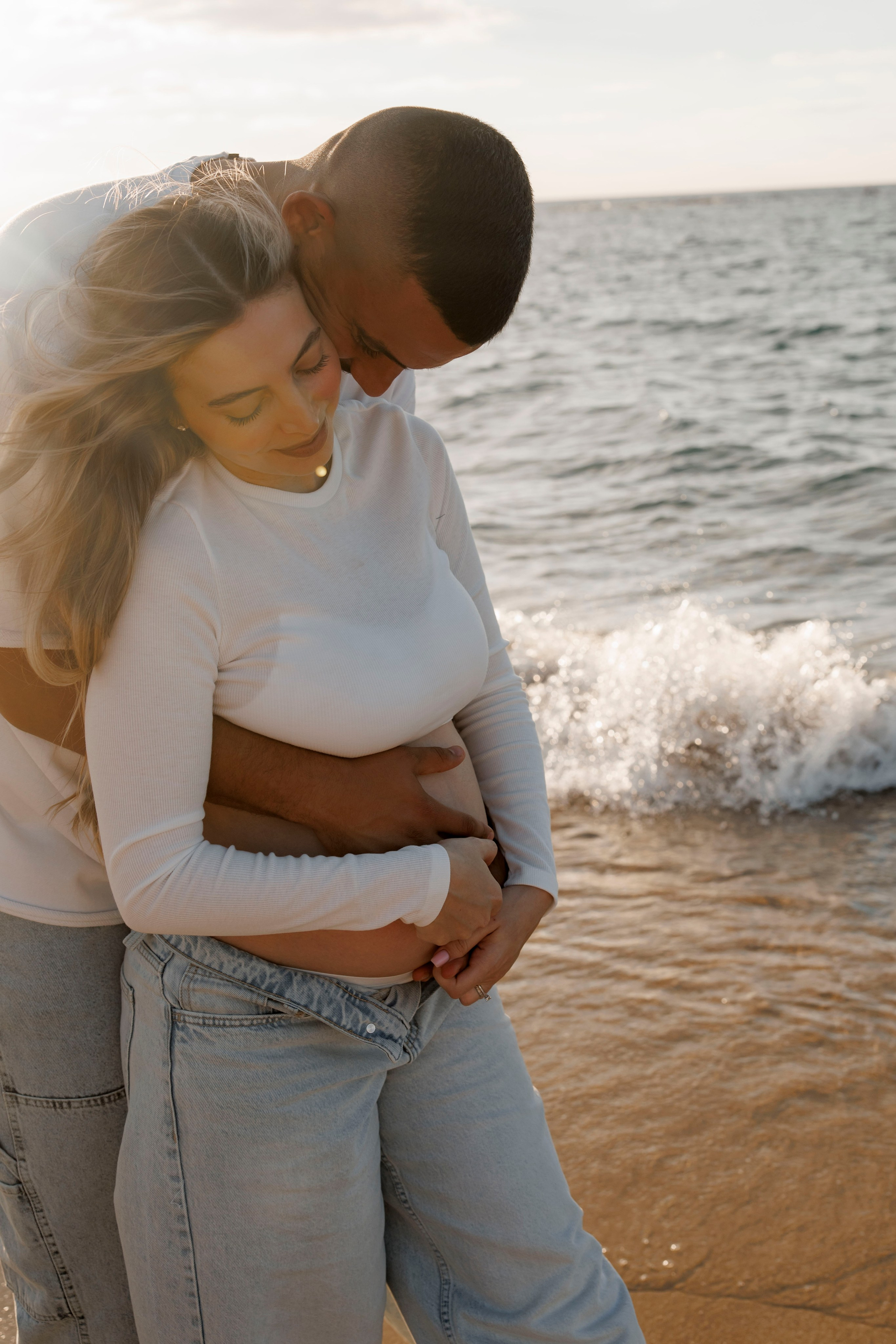 Pregnancy photoshoot near the sea. Wedding and family photographer