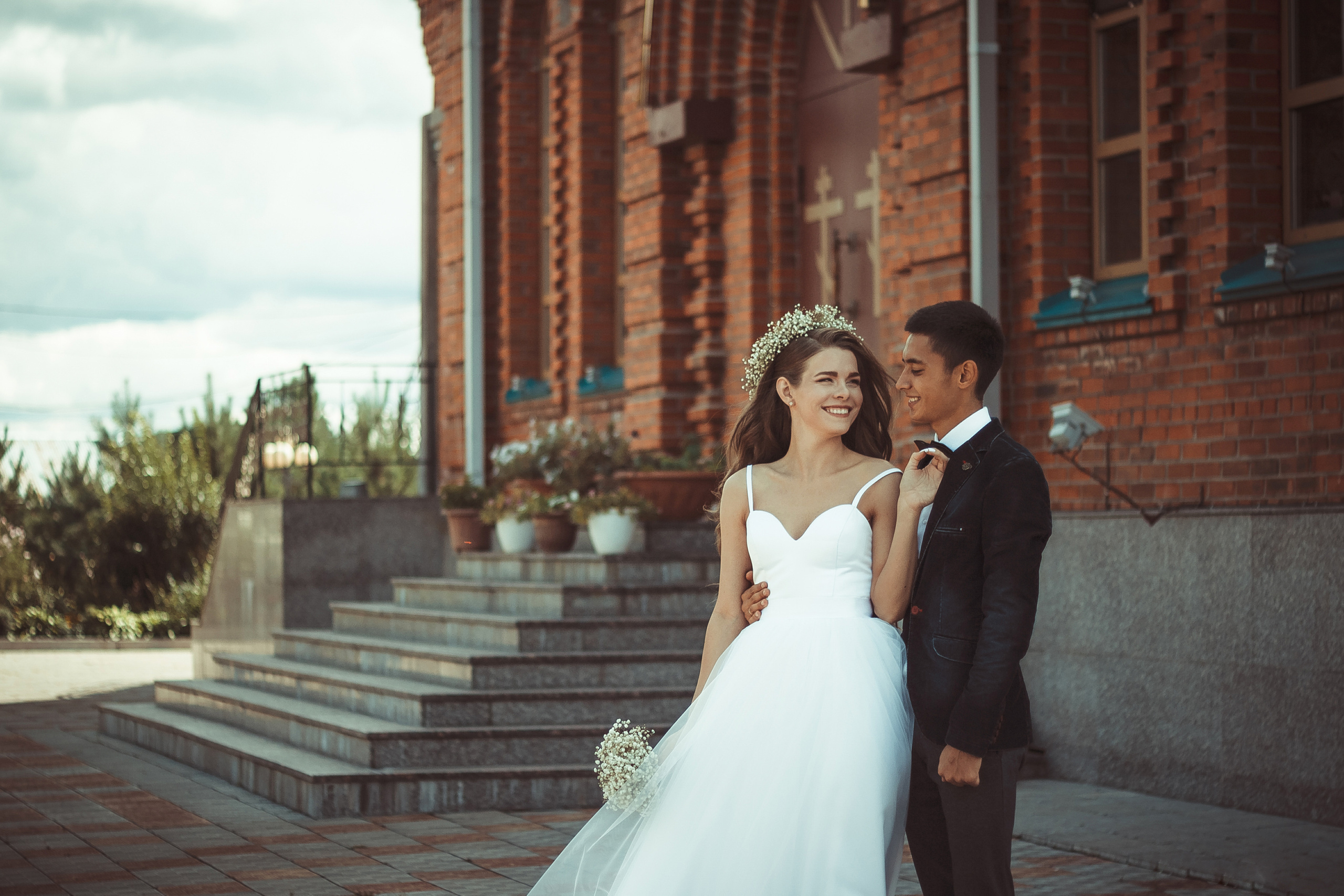 Молодожёны влюблённая пара на фоне церкви фотография в американском стиле