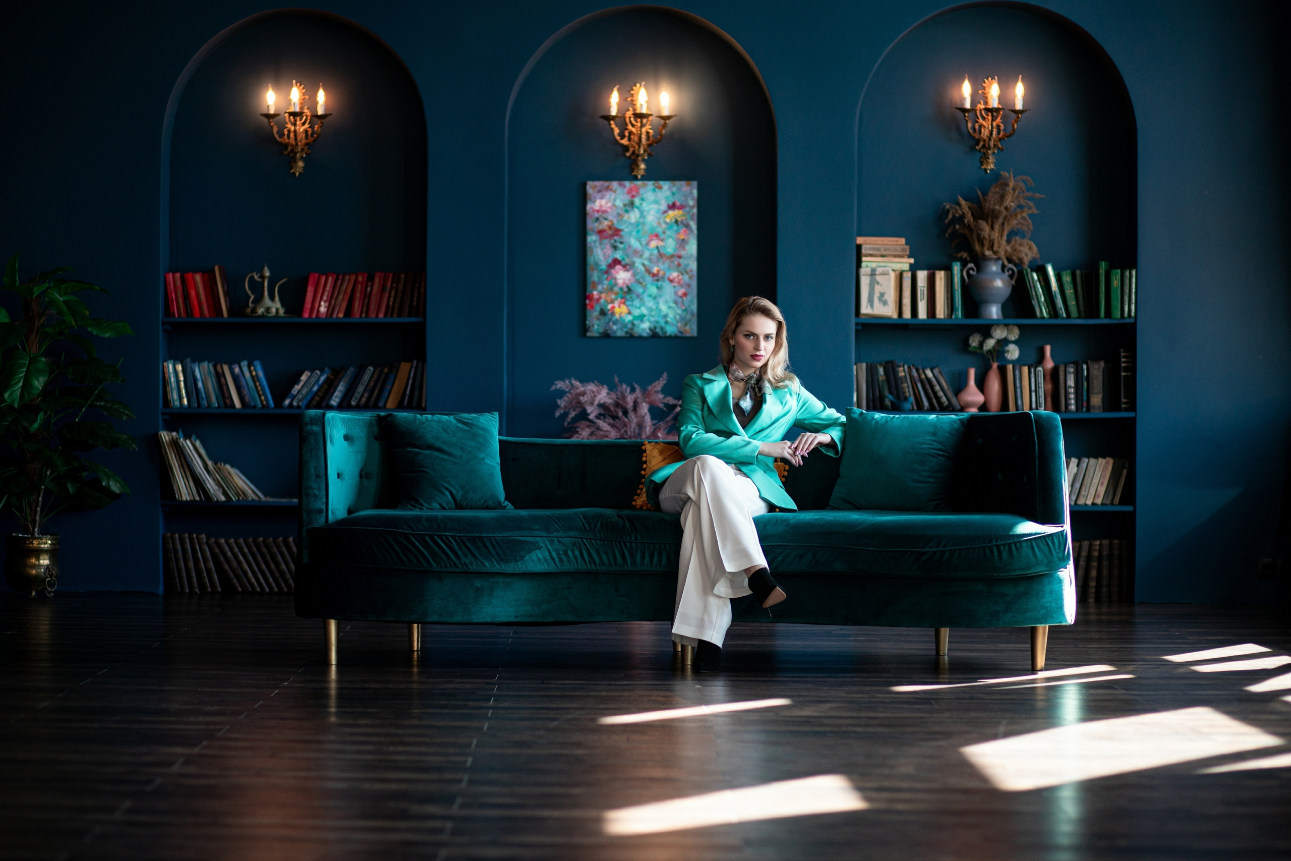 Модель в синем зале фотостудии в бирюзовом пиджаке на диване. Бизнес фотосессия во Владивостоке