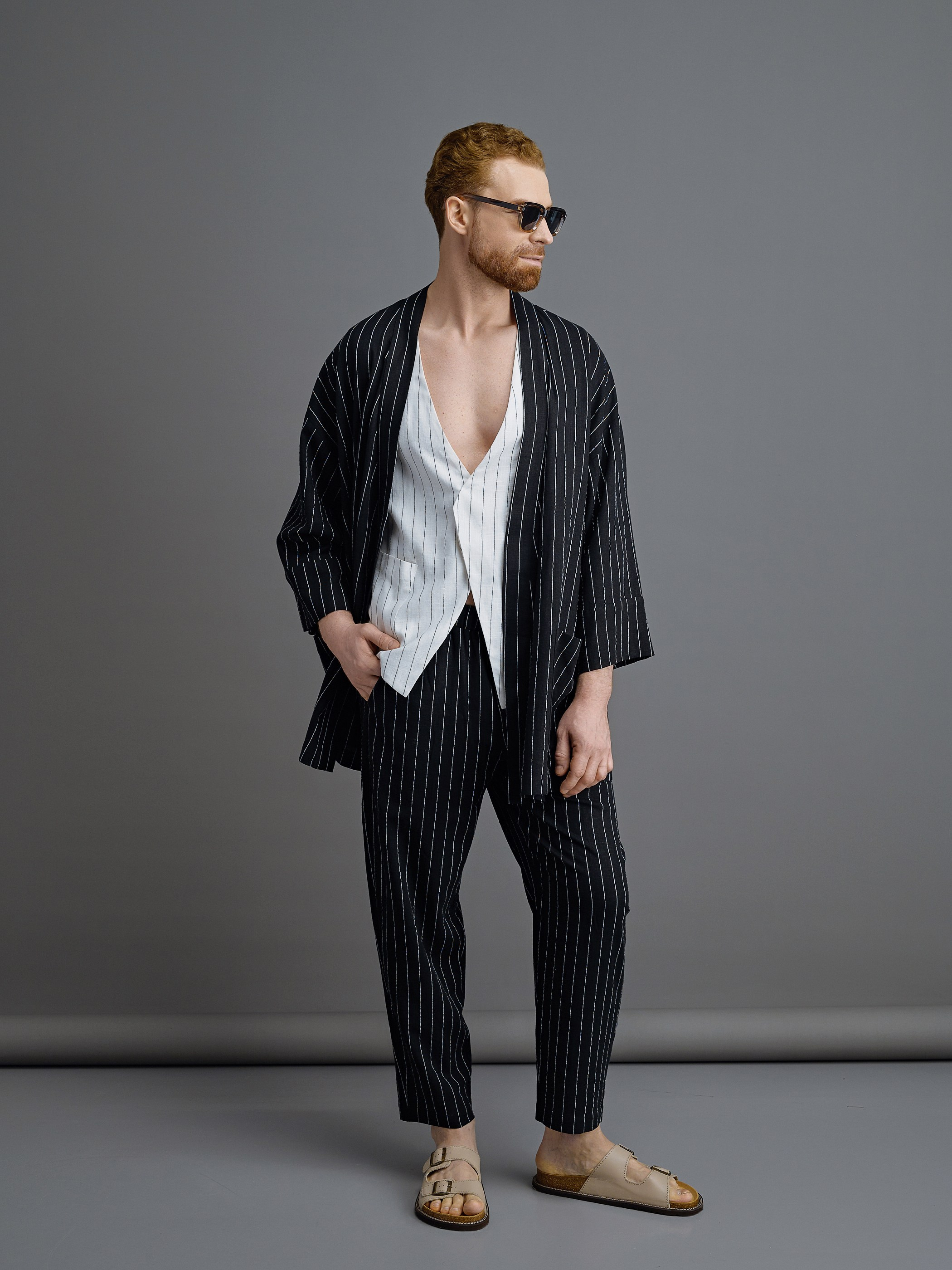 Мужчина модель в черной рубашке и черных брюках