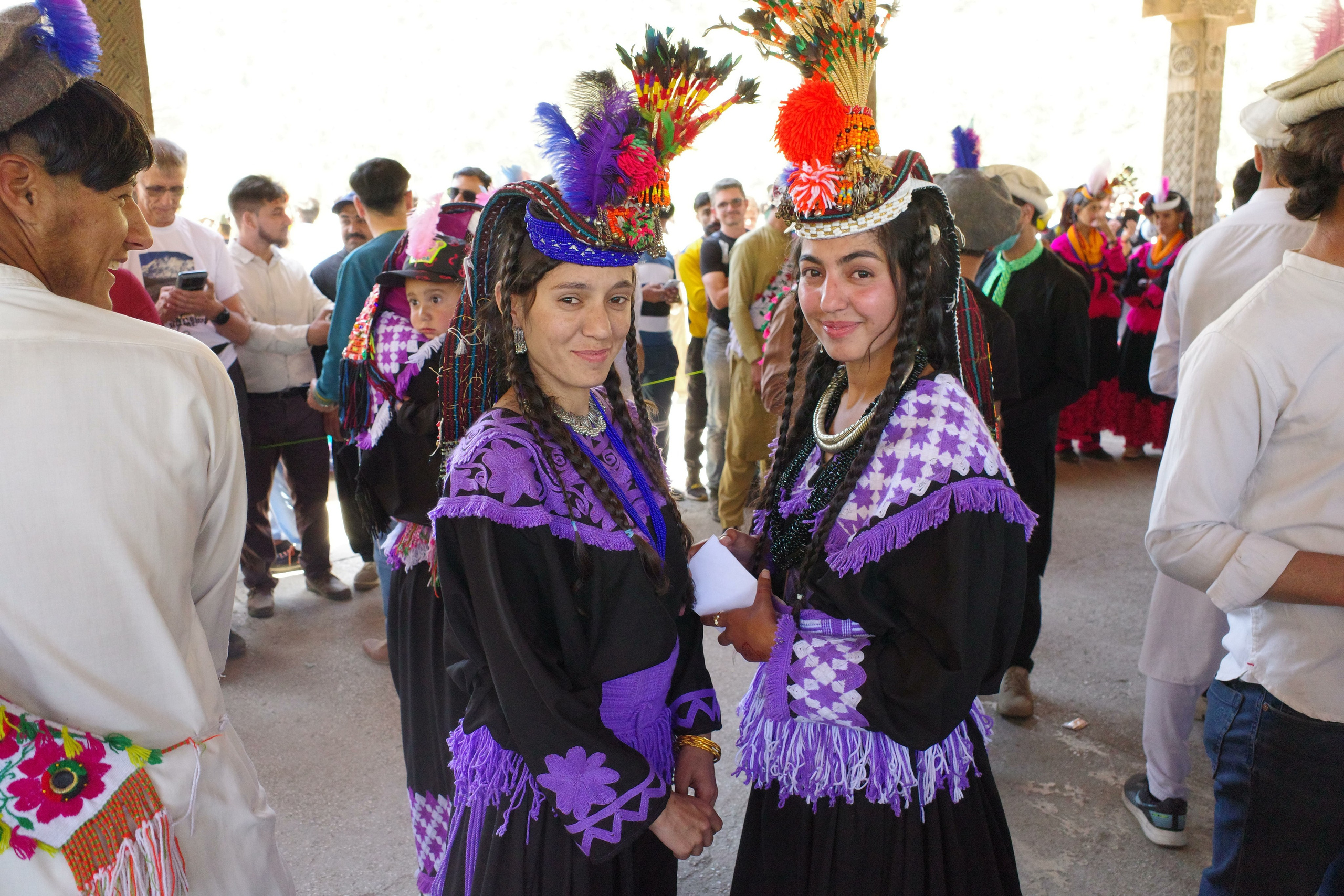 Women in traditional costumes prepare to perform a folk dance at the Chilam Joshi festival