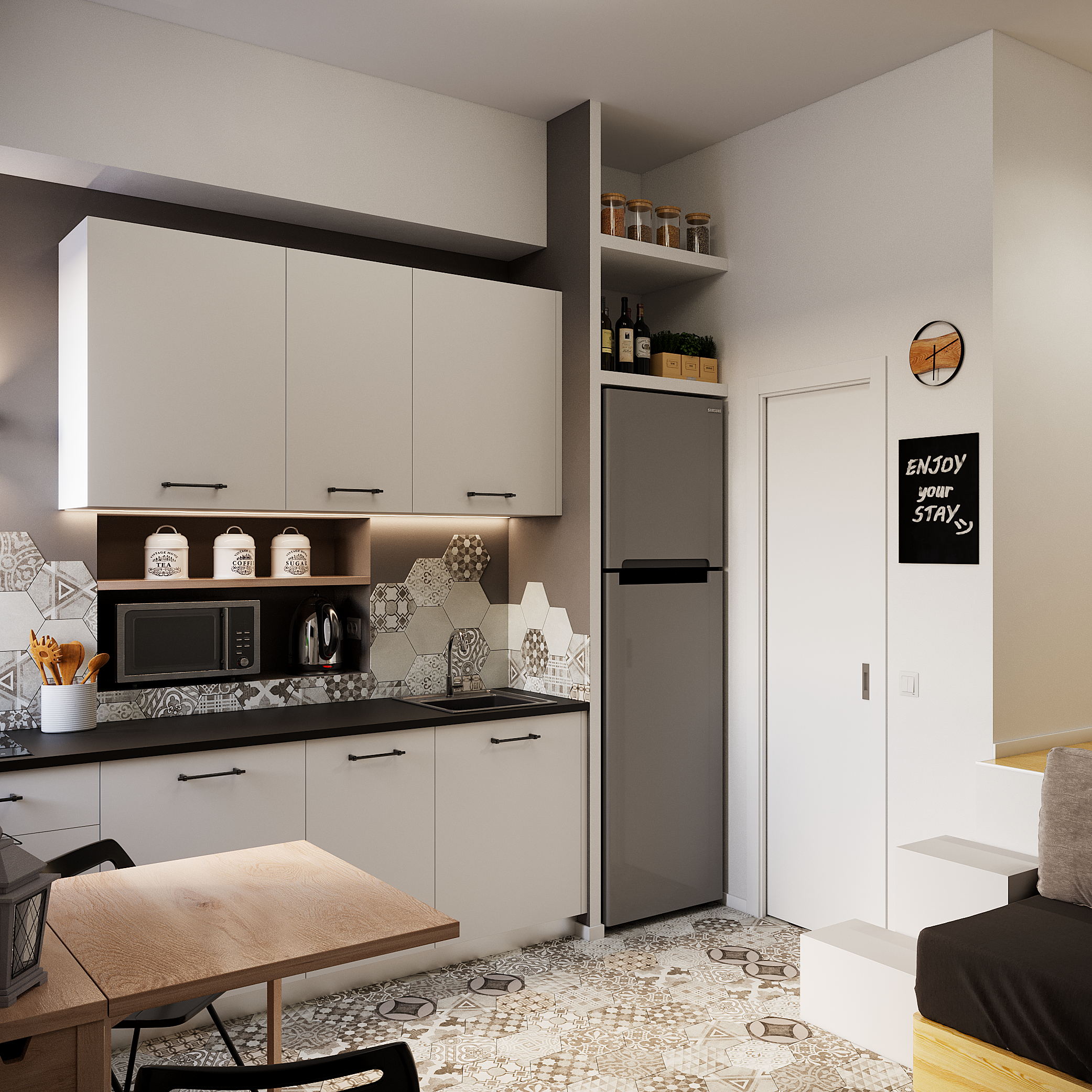 Современная кухня в студии с белыми шкафами и высоким холодильником в нише.