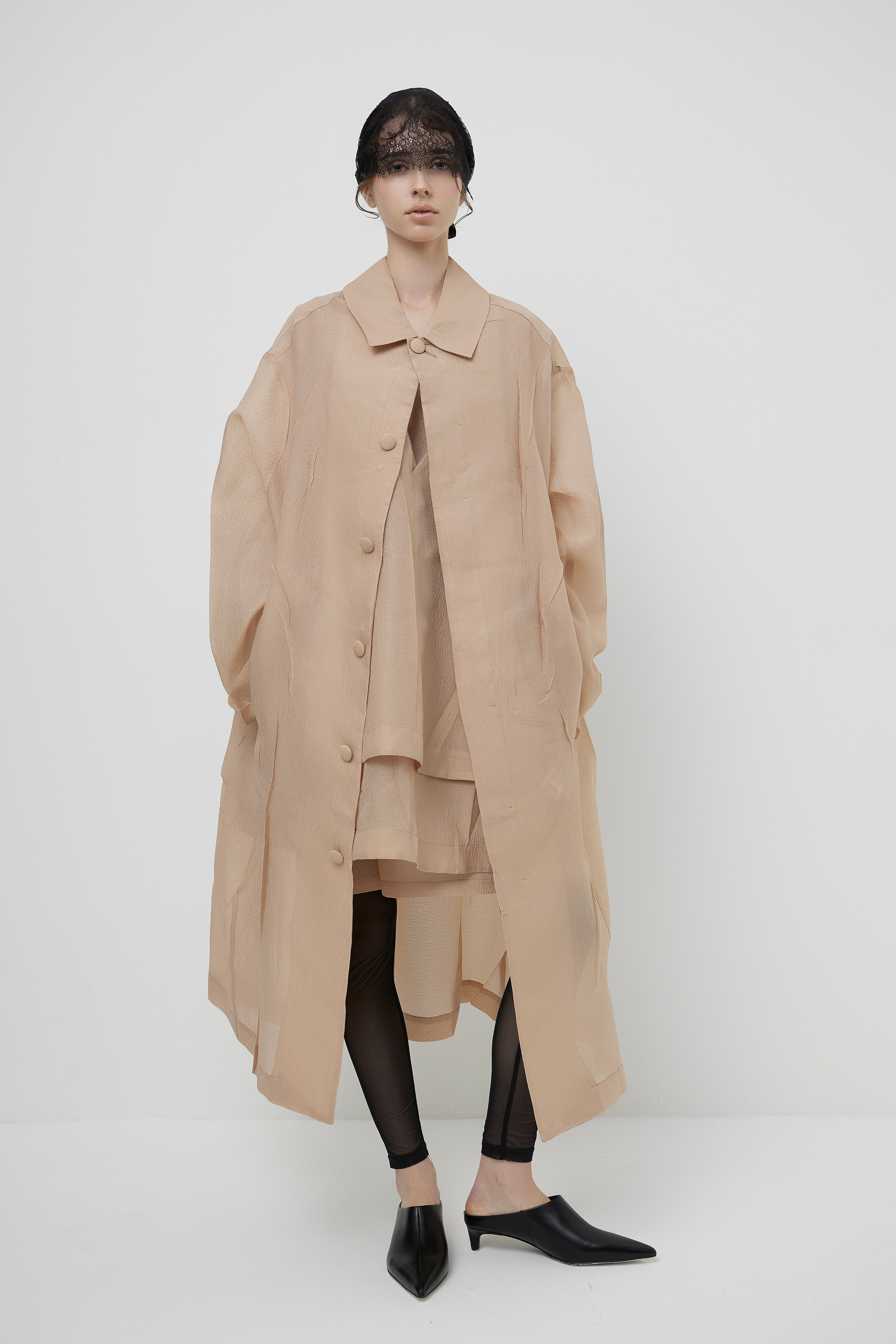 Full body fashion lookbook image of model wearing minimalist beige designer coat photographed for fashion brand ecommerce and campaign photography in Sydney