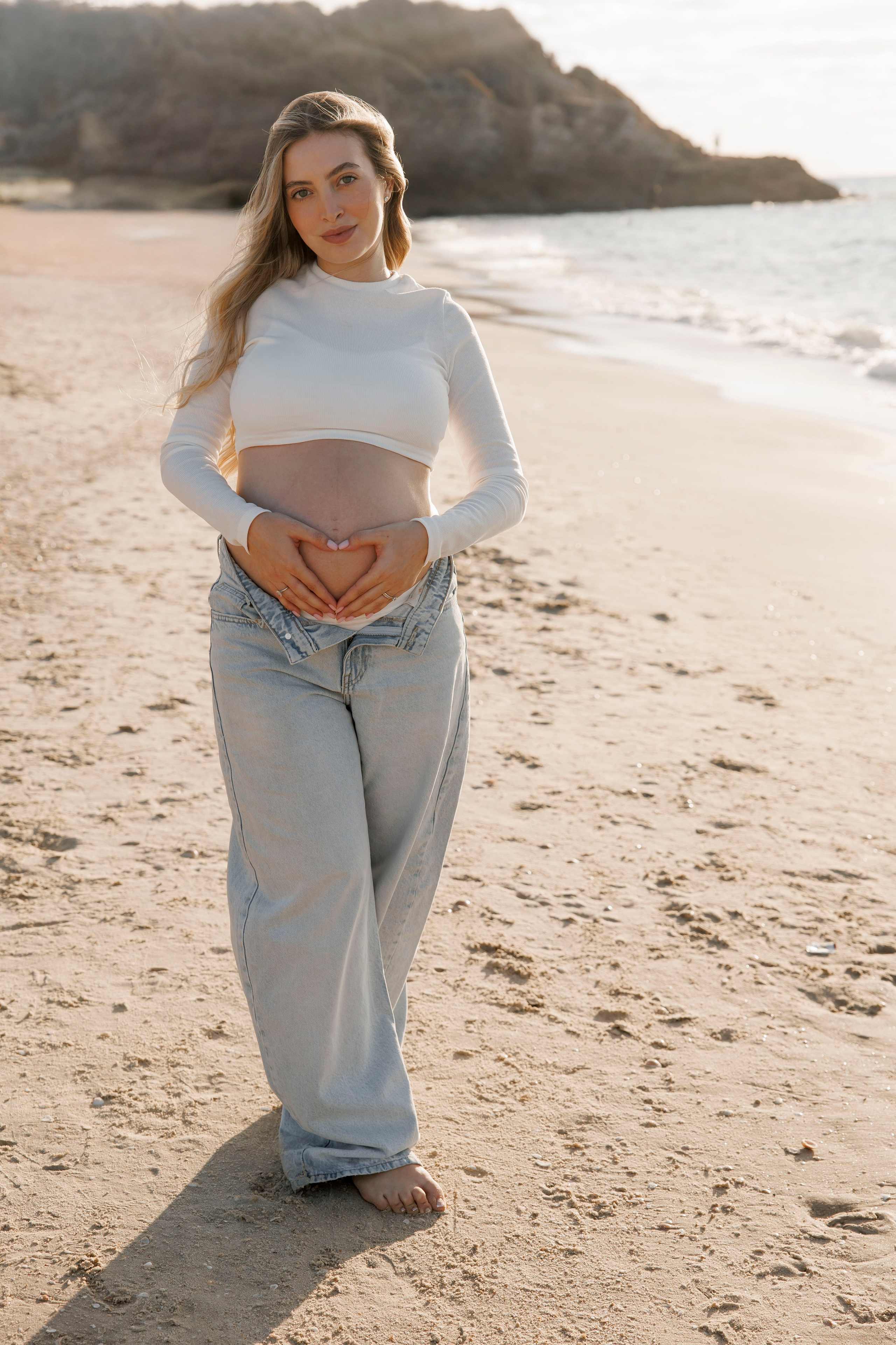 Pregnancy photoshoot near the sea. Wedding and family photographer