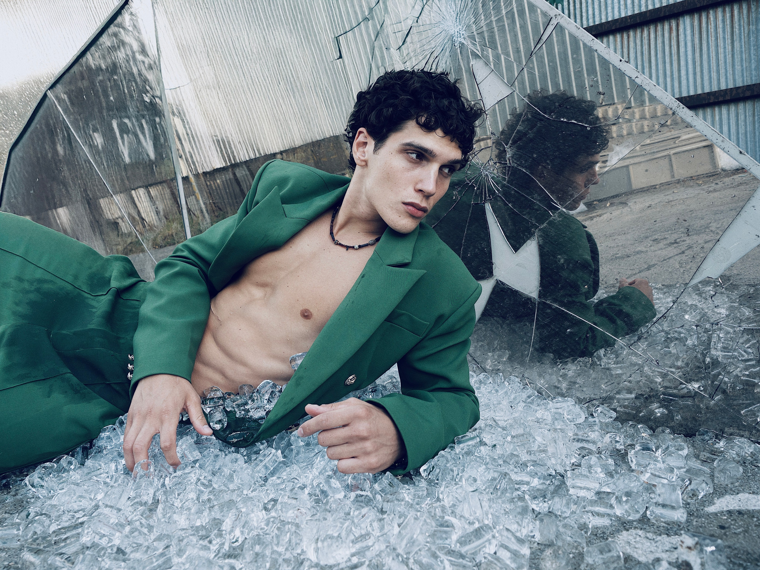 Fashion editorial portrait of Cem Kurttekin in a green jacket, photographed by Sergio Maiis