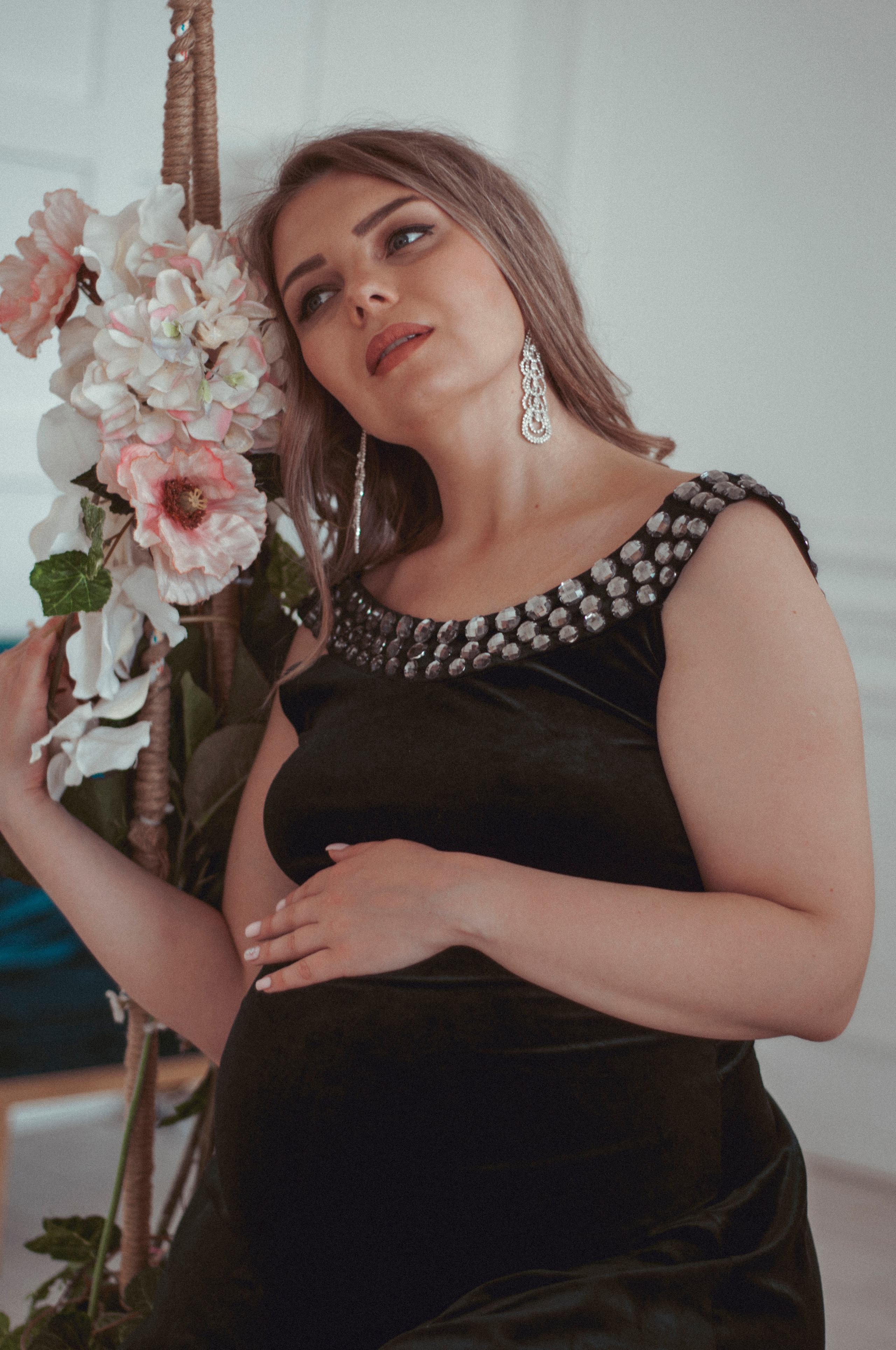 Беременная на качелях в фотостудии