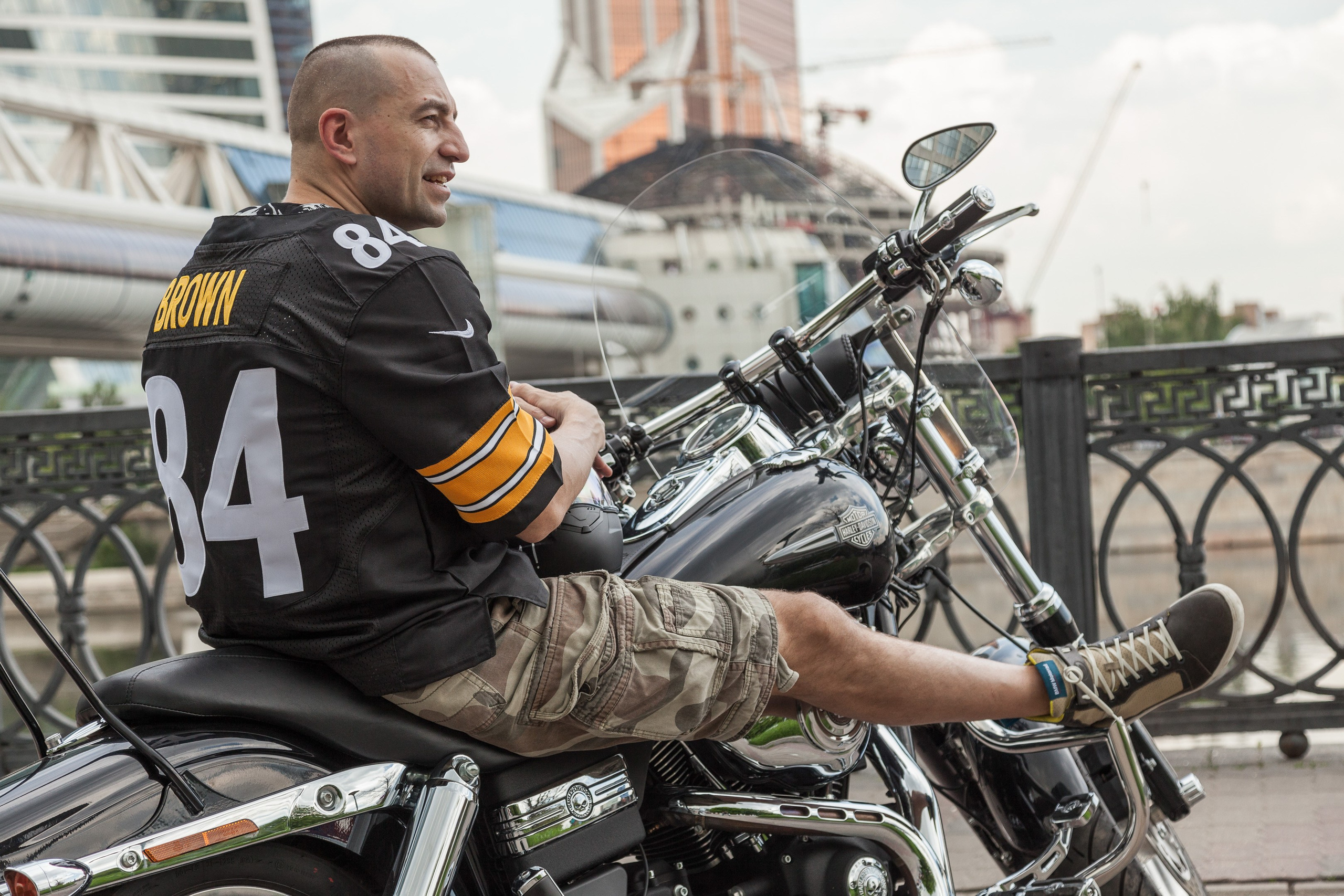 Location portrait of a biker on a Harley Davidson motorcycle in city landscape - photographer Andrey Dunin