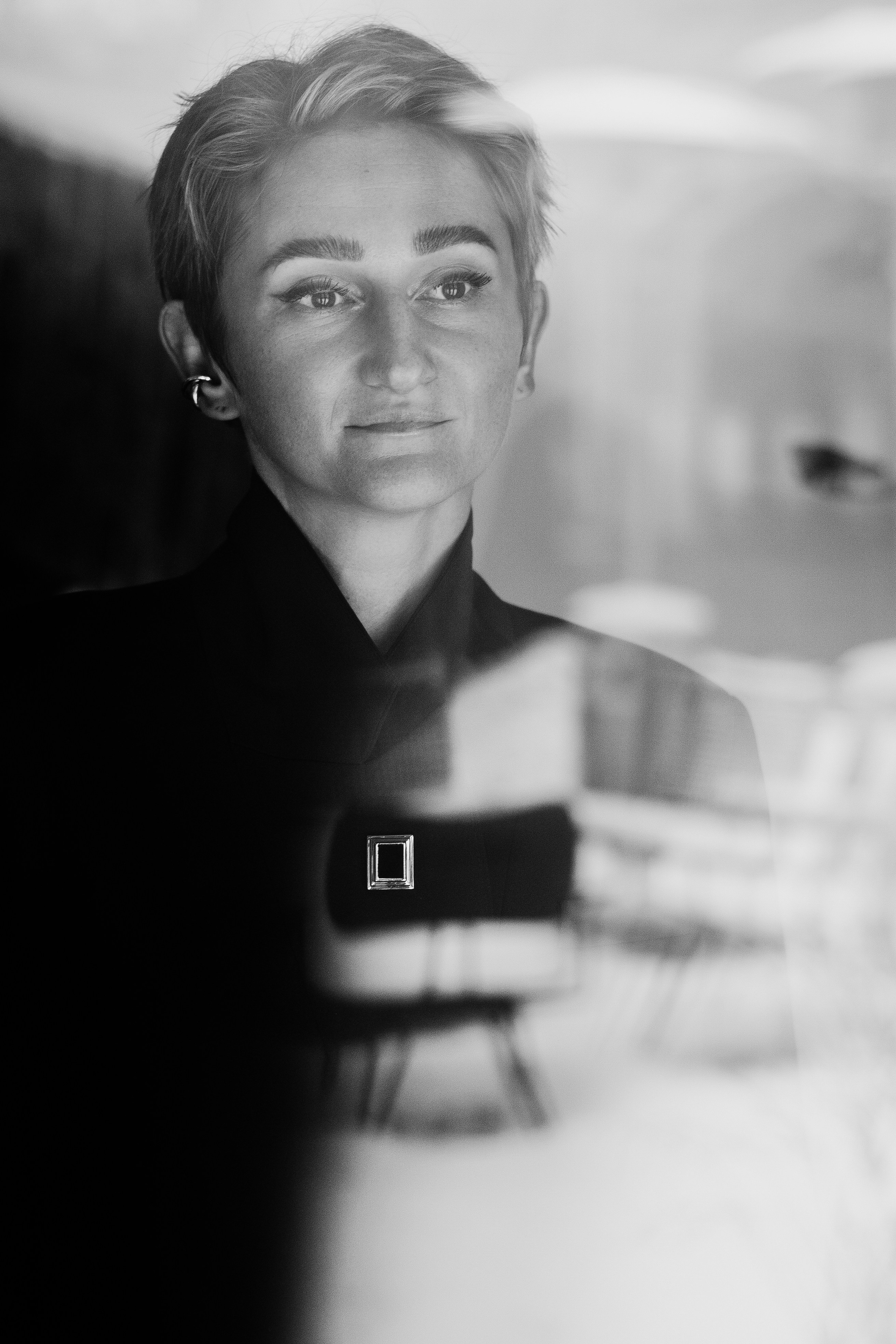 Black and white portrait of a woman with short hair, soft window light. Photo: Anna Ulianova